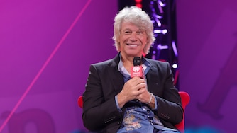 BURBANK, CALIFORNIA - OCTOBER 09: Jon Bon Jovi speaks onstage during the iHeartRadio album preview featuring Bon Jovi's "Forever" (Legendary Edition) at iHeartRadio Theater on October 09, 2025 in Burbank, California. (Photo by Kevin Winter/Getty Images for iHeartRadio)