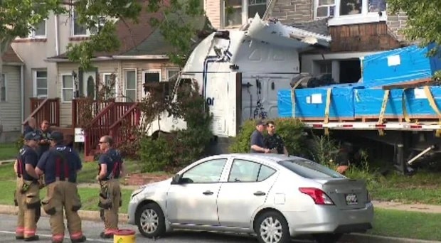 A tractor trailer crashed into homes in Dundalk on Wednesday afternoon. The driver was hospitalized, and a family was displaced.