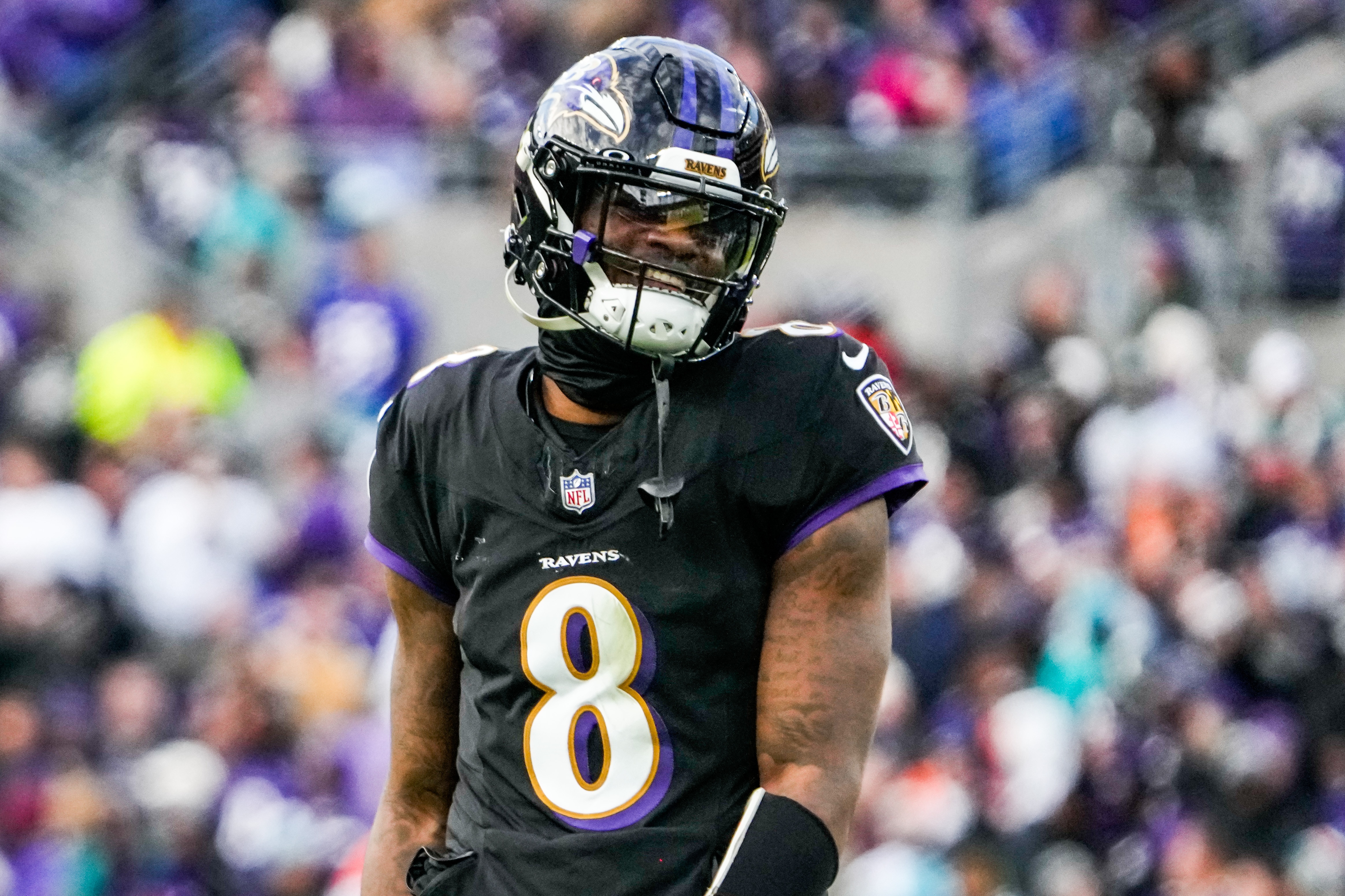 Baltimore Ravens quarterback Lamar Jackson (8) smiles between plays during the fourth quarter against the Miami Dolphins at M&T Bank Stadium on Sunday, Dec. 31, 2023.