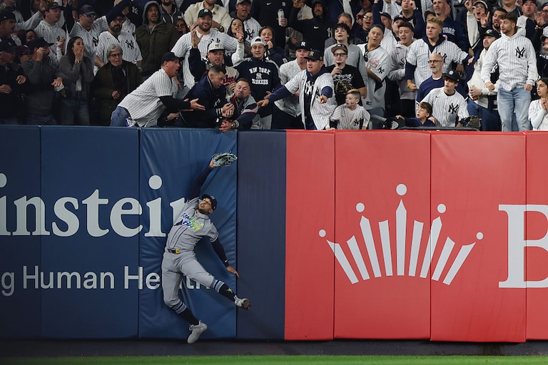 Tampa Bay Rays outfielder Victor Mesa Jr. is unable to make a catch as fans interfere on a ball hit by New York Yankees infielder Anthony Volpe during the sixth inning in Game 3 of the American League Division Series on Wednesday.