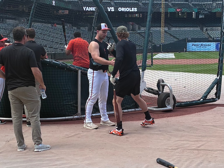 Orioles first baseman Pete Alonso helps guide shortstop Gunnar Henderson on aspects of his swing during batting practice before the team's game against the New York Yankees on August 19, 2026.
