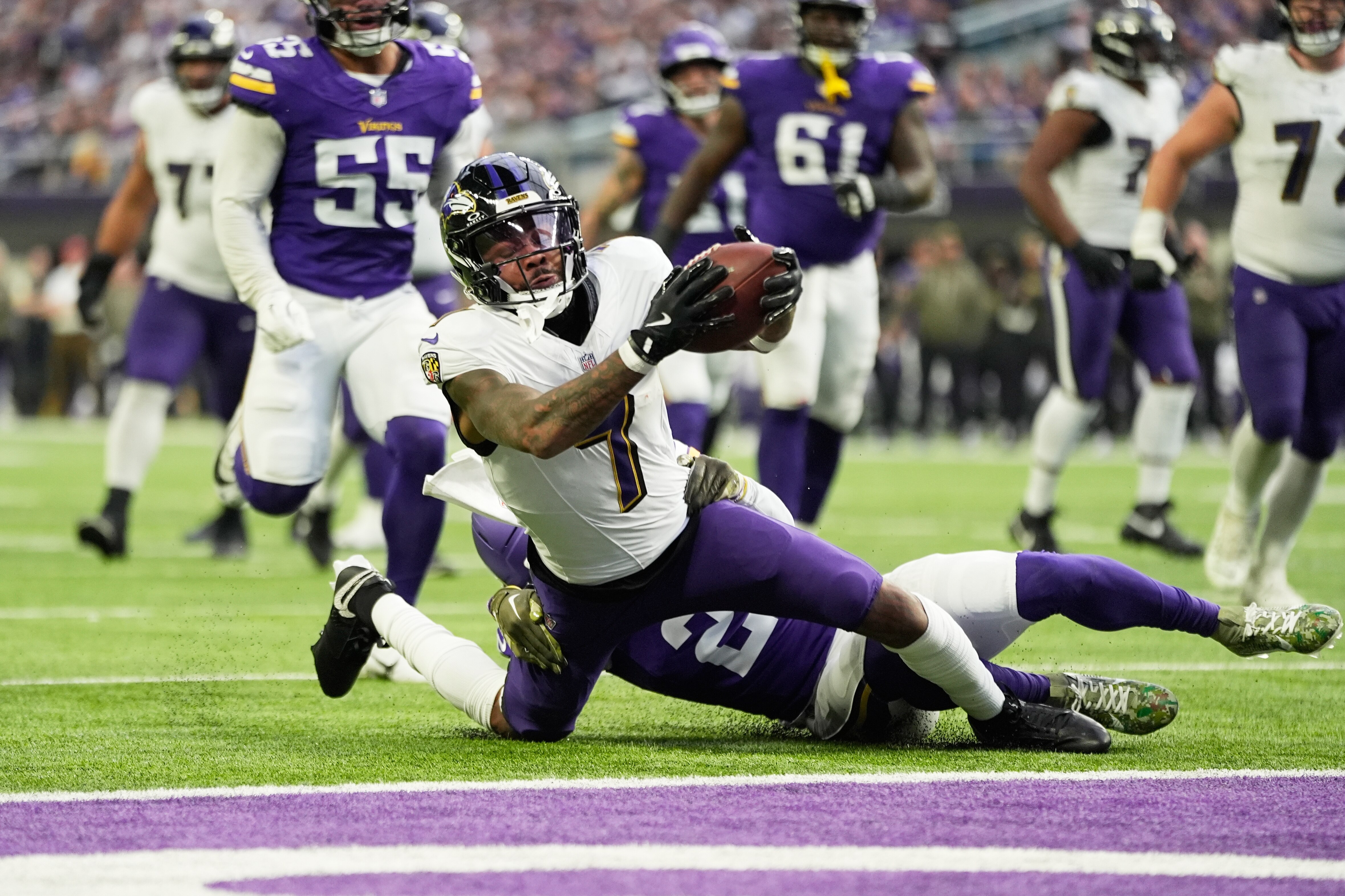 Baltimore Ravens wide receiver Rashod Bateman (7) is tackled by Minnesota Vikings cornerback Isaiah Rodgers (2) short of a touchdown in the second half of an NFL football game, Sunday, Nov. 9, 2025, in Minneapolis.