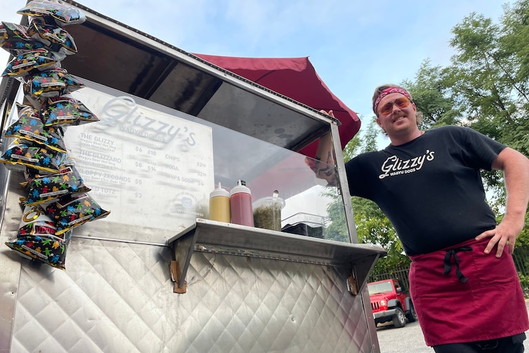 Casey Jarvis stands with his traveling hot dog cart, Glizzy's Wagyu Dogs. Jarvis previously worked at Chuck's Trading Post and Blue Pit BBQ.