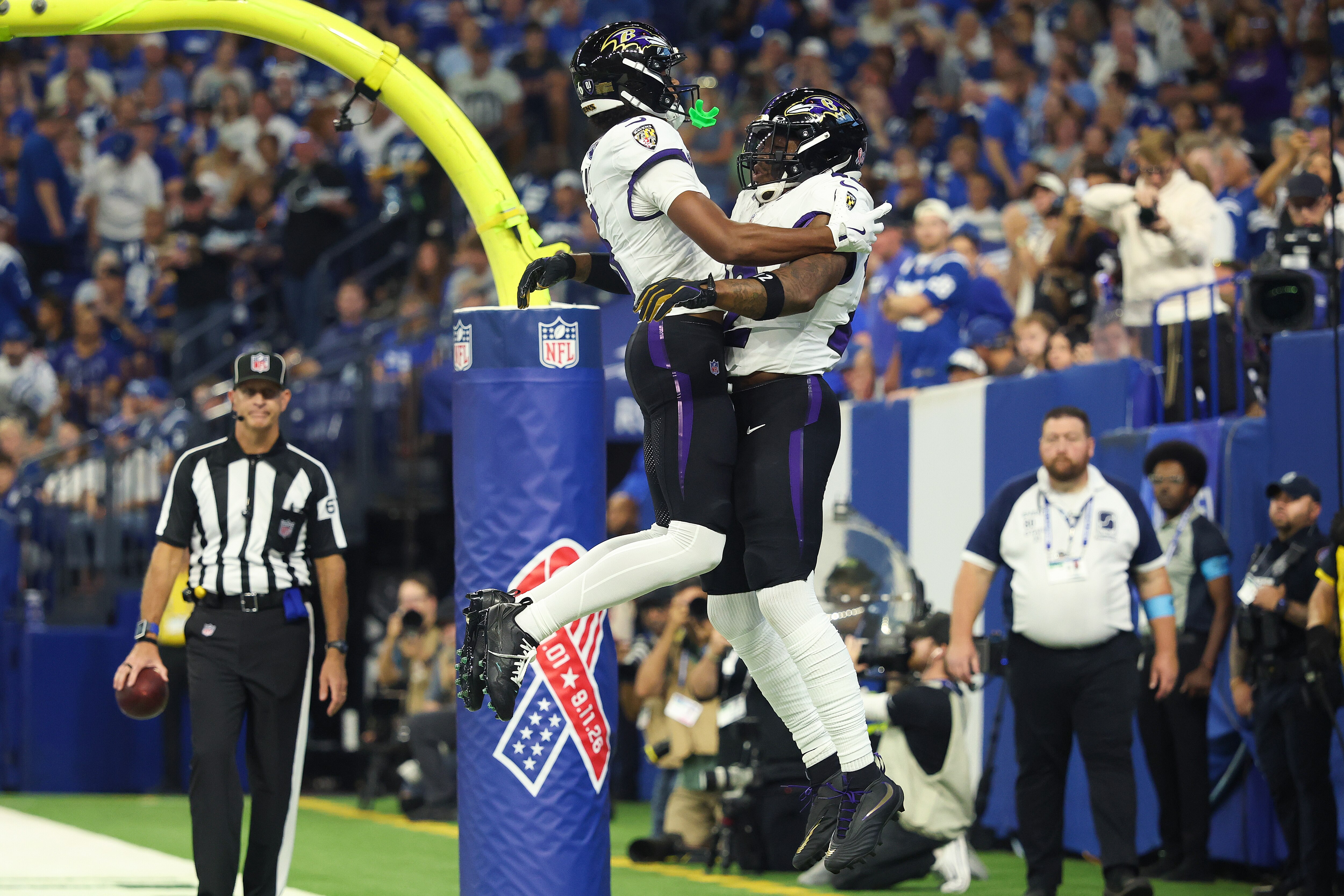 Ravens running back Derrick Henry celebrates with Ja’Kobi Lane after scoring one of his three touchdowns Sunday against the Colts.