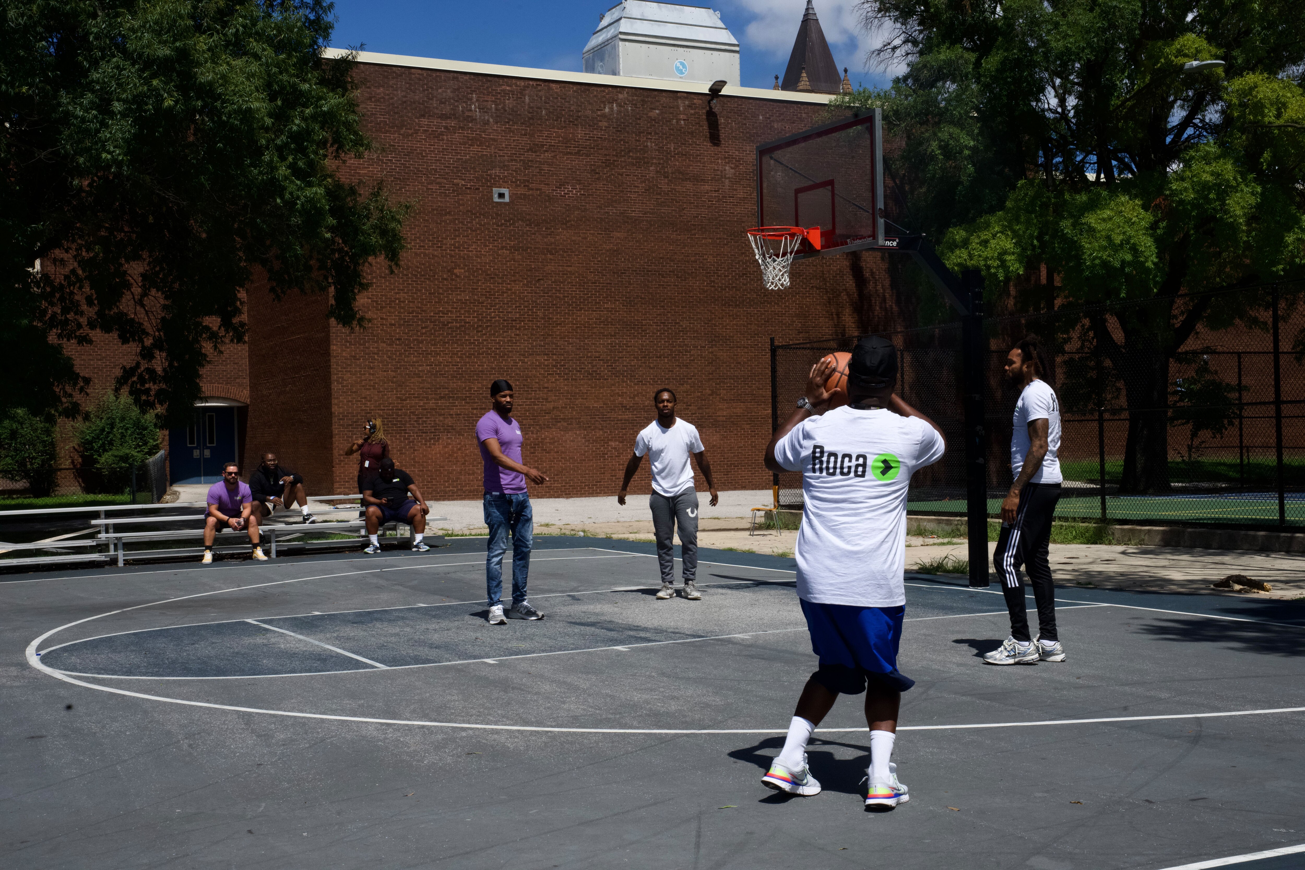 ROCA members playing basketball in the court where the shooting happened.