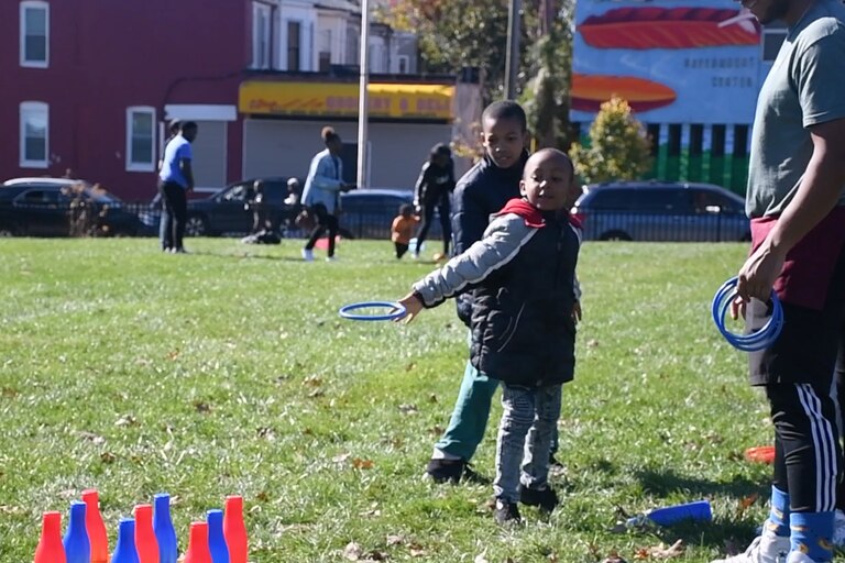 A child plays ring toss at the East Baltimore Graffiti Church's Fall Festival.