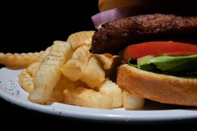 NuVegan crab cake sandwich with fries.