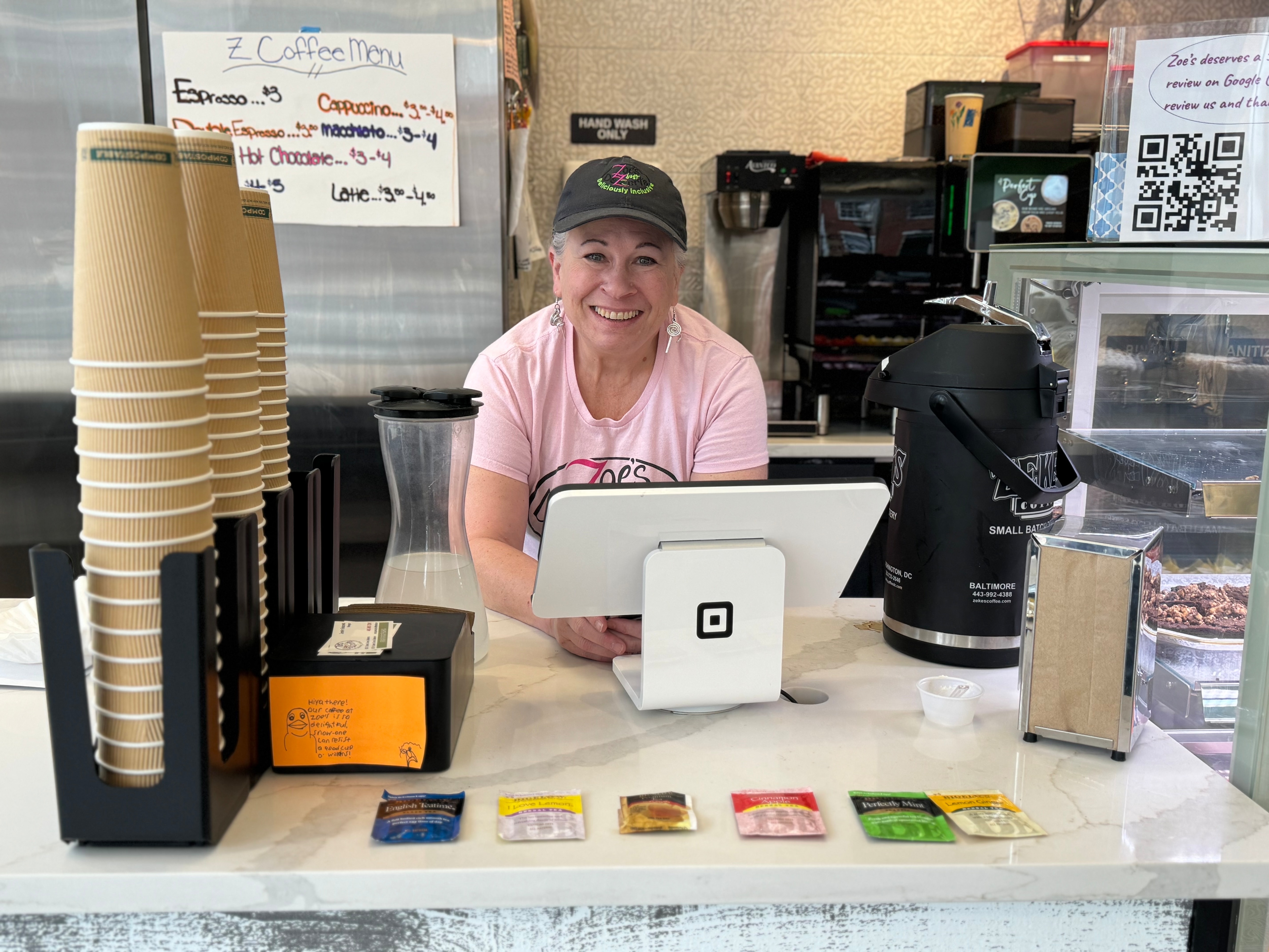 Jennifer Goldszmidt, co-owner of Zoe's Just Dezzerts, stands at the register of the Federal Hill storefront.