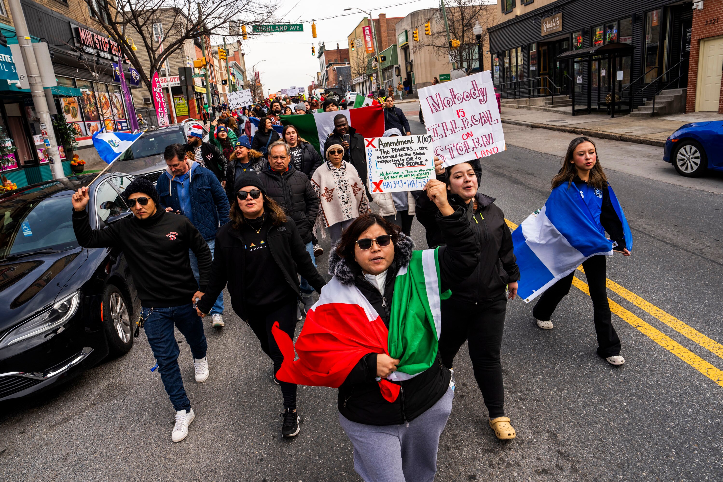 More than 150 people rallied for immigrants rights by the Enoch Pratt Free Library Southeast Anchor Branch, marching down Eastern Avenue on Monday.