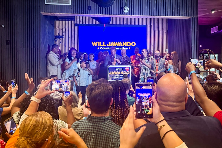 TUESDAY, JUNE 23, 2026 - Supporters cheer for Will Jawando as he speaks at his watch party at Citizens and Culture in Silver Spring on Tuesday evening. As of his speech, he was leading by six points.