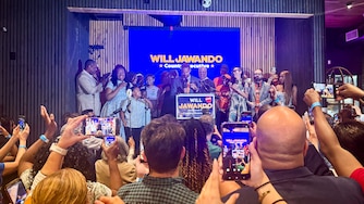 TUESDAY, JUNE 23, 2026 - Supporters cheer for Will Jawando as he speaks at his watch party at Citizens and Culture in Silver Spring on Tuesday evening. As of his speech, he was leading by six points.