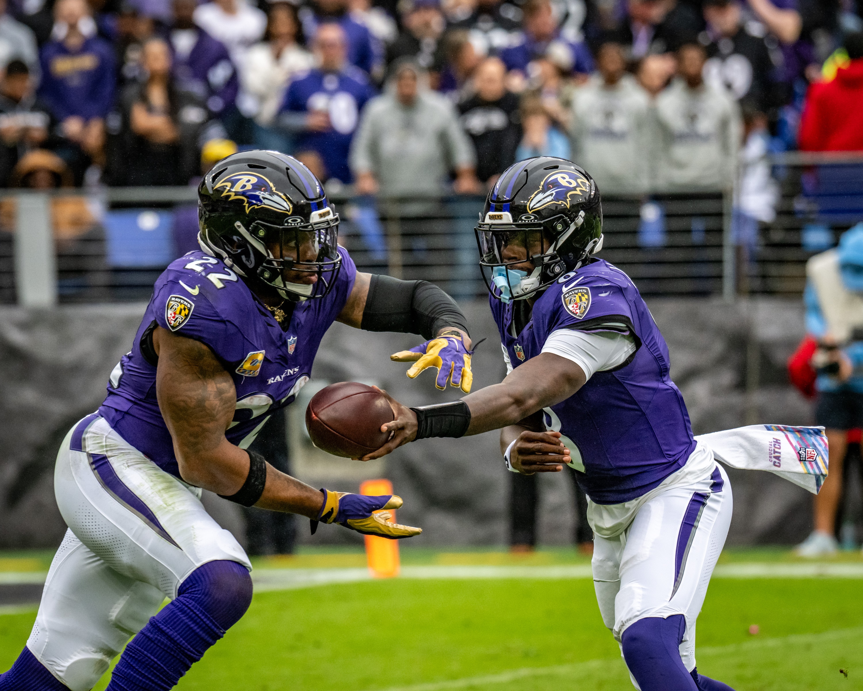 Ravens quarterback Lamar Jackson (8) hands off to running back Derrick Henry (22) as the team hosts the Tennessee Titans on Oct. 4.