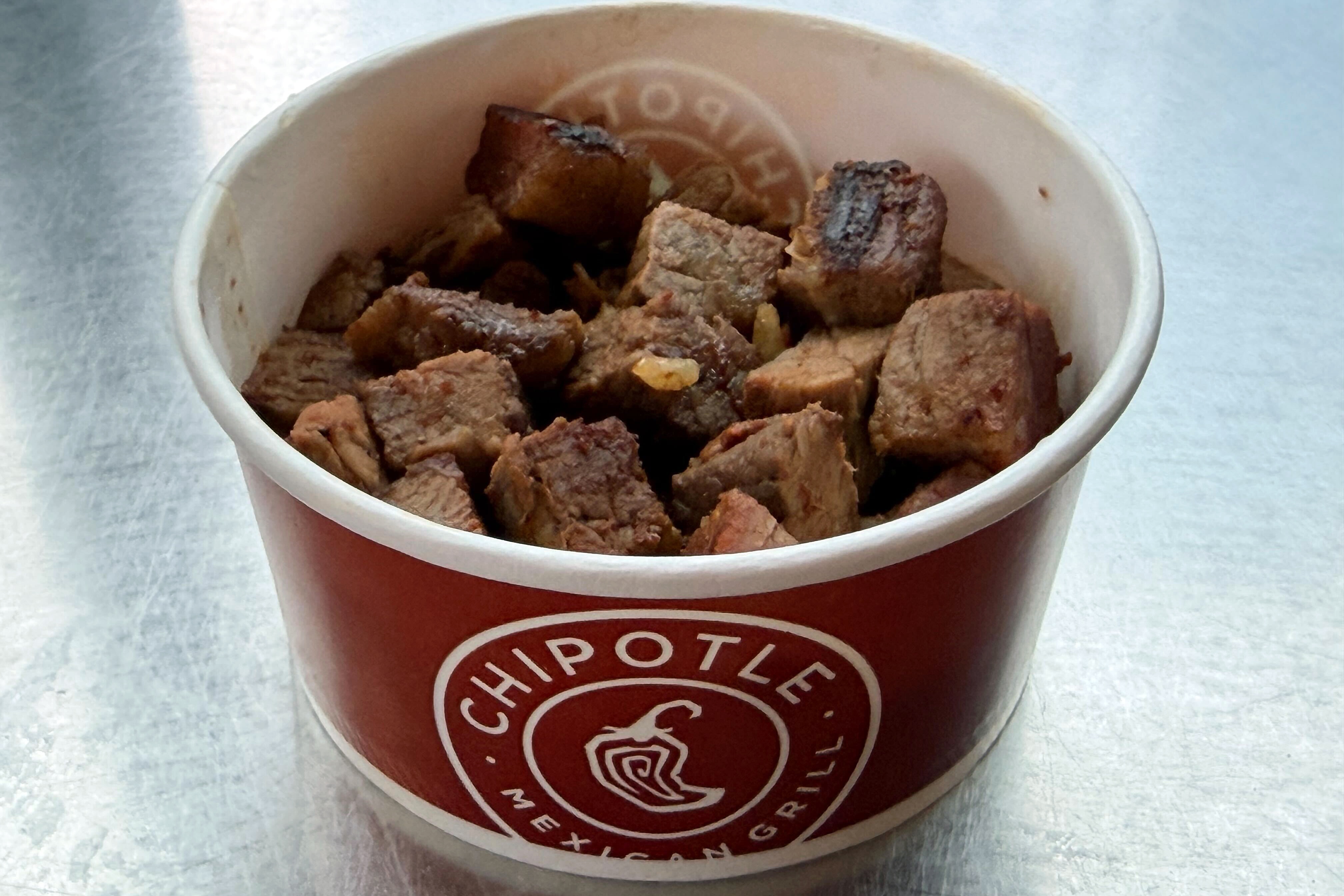 Chipotle unveiled its “first-ever high protein” menu on Dec. 23. One of the offerings is a snack-size cup of cubed steak that has 21 grams of protein and looks like what you'd feed a dog for its birthday.
