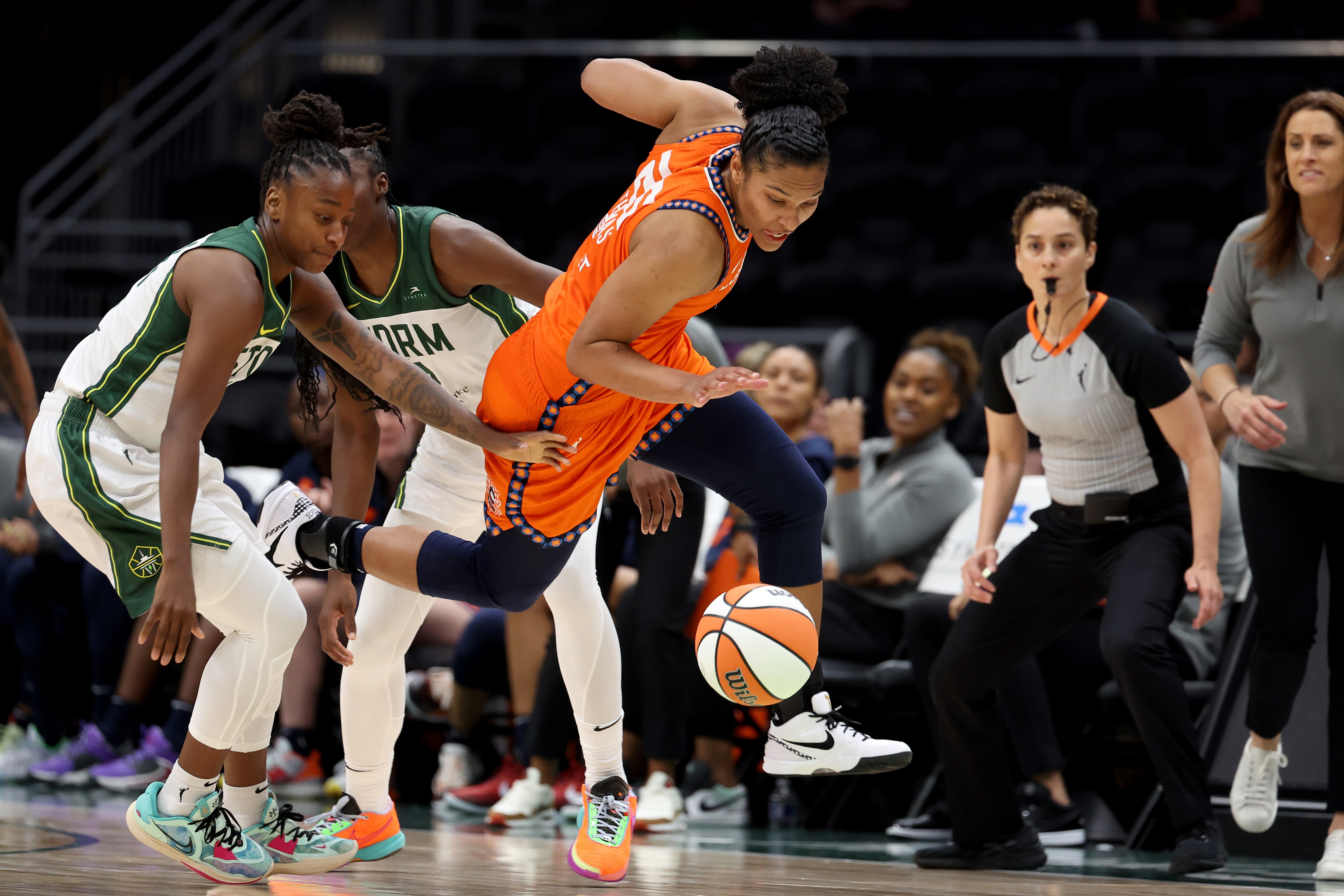 Alyssa Thomas (center) of the Connecticut Sun, shown in action last week, set a league record with her fourth triple-double Sunday.