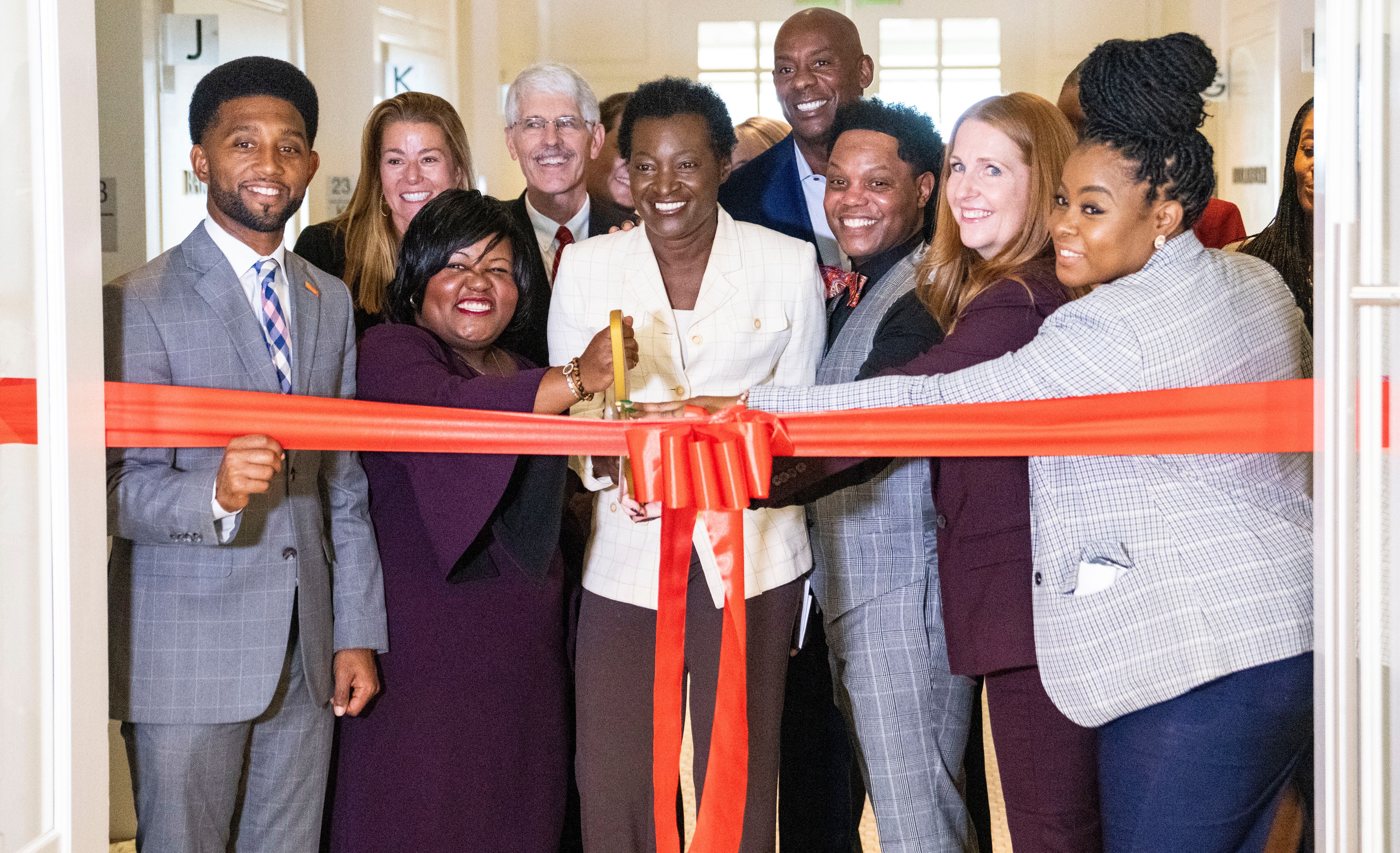 Theresa Harrison CEO of George Street Services cuts a ribbon after Baker Donelson, a national law firm, held a press conference at their Light Street building, in Baltimore, Tuesday, October 11, 2022.  Baker Donelson announced a donation the twenty-third floor of its Baltimore office on Light Street to 26 small minority and women-owned businesses.