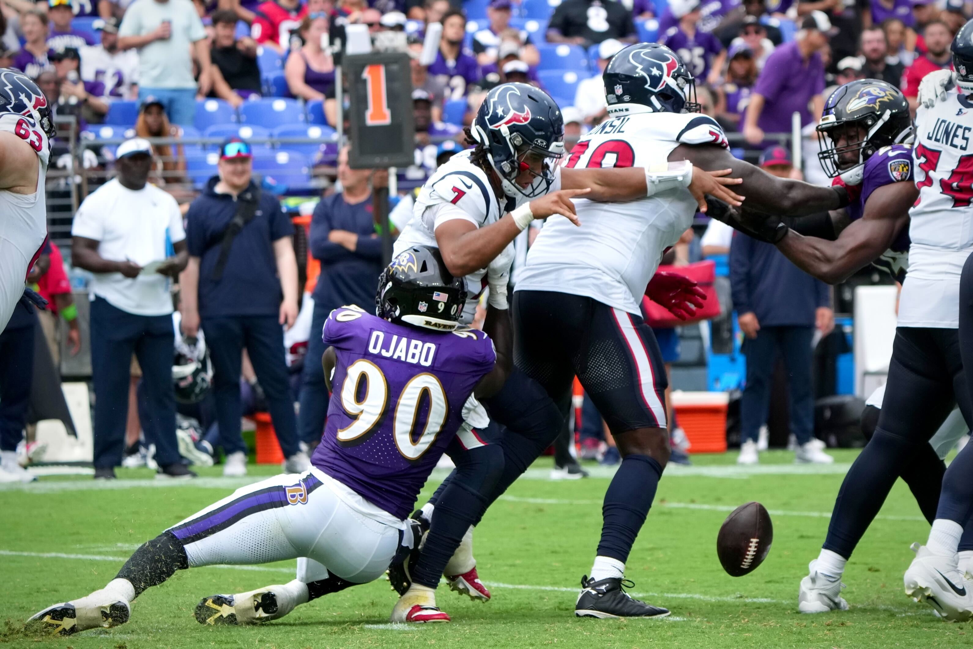 Linebacker David Ojabo forces Houston quarterback C.J. Stroud to fumble during the season-opening game.