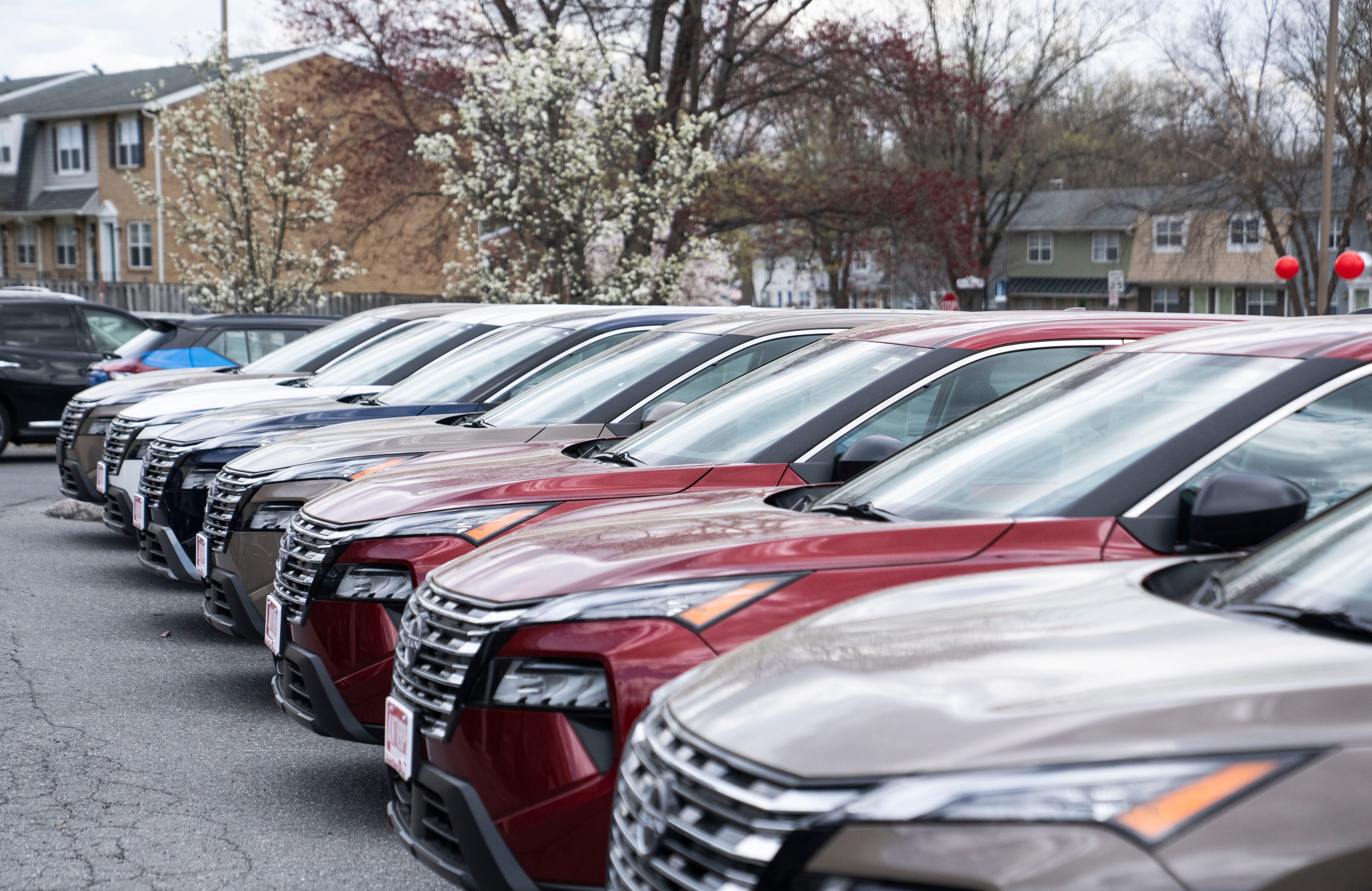 Cars, like those pictured for sale in the lot of Antwerpen Nissan of Owings Mills, will cost more as tariffs get absorbed by consumers.
