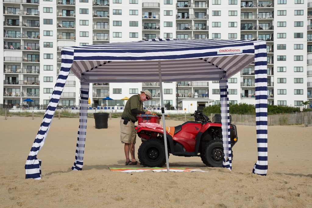 Tim Miller writes up an unattended canopy on the beach in Ocean City on Aug. 16.