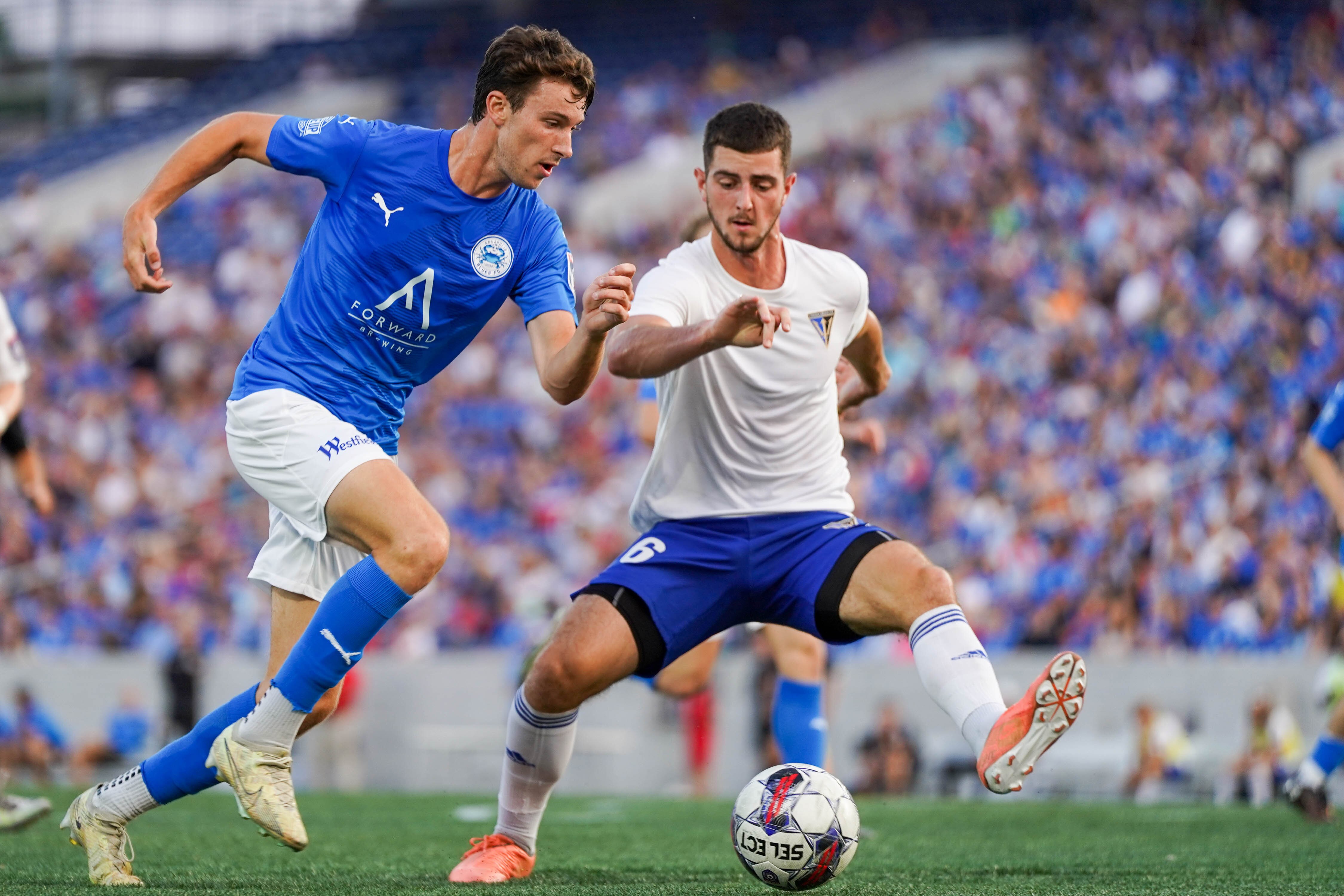 Annapolis Blues forward Jacob Murrell (18) fights for the ball during their game against VB City on June 11, 2023. Annapolis won 3-0.  The team returns to Navy-Marine Corps Memorial Stadium next week with a charity game.