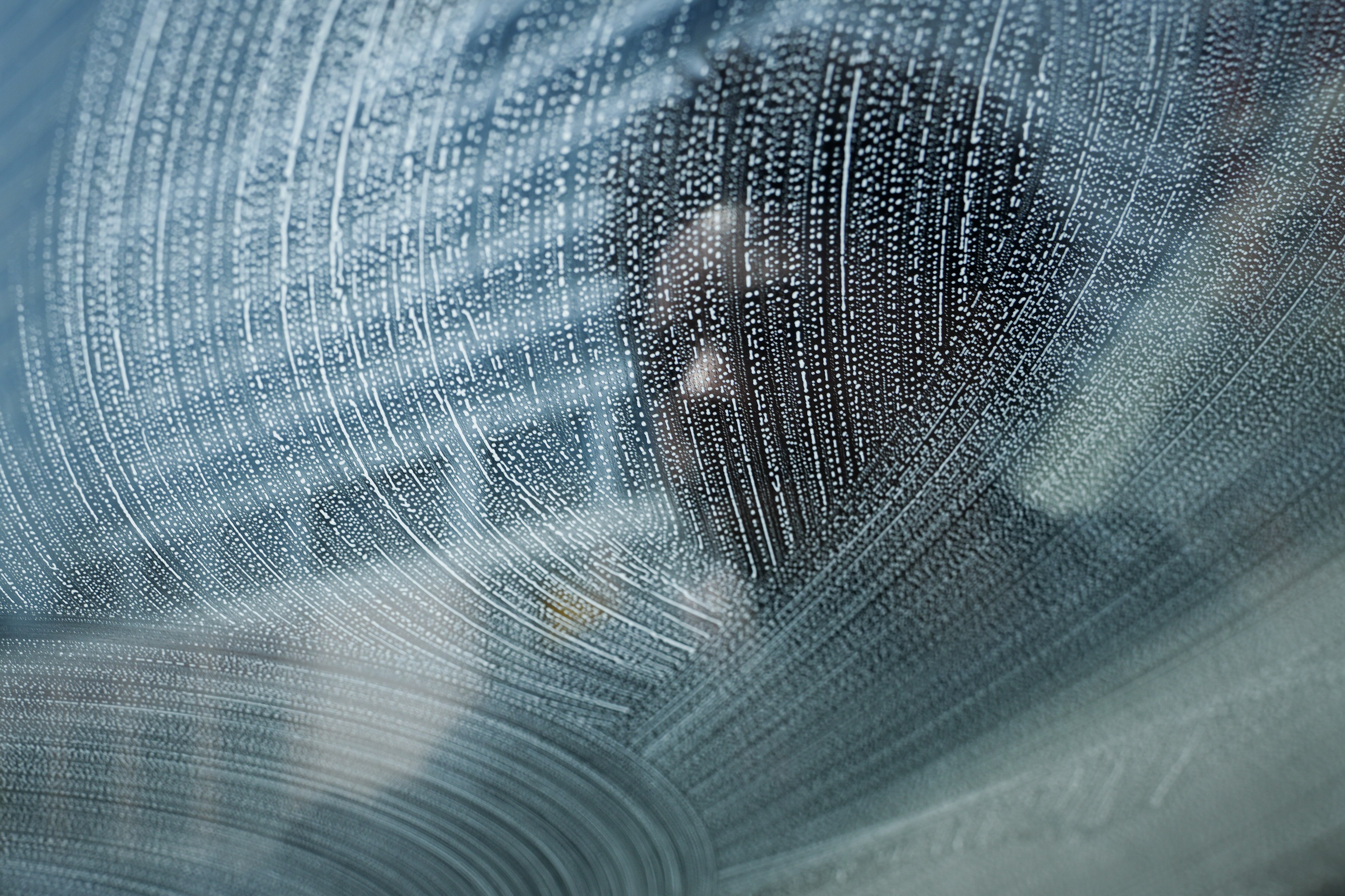 7/8/22—A squeegee worker cleans a windshield at the corner of E Lombard St. & President St.