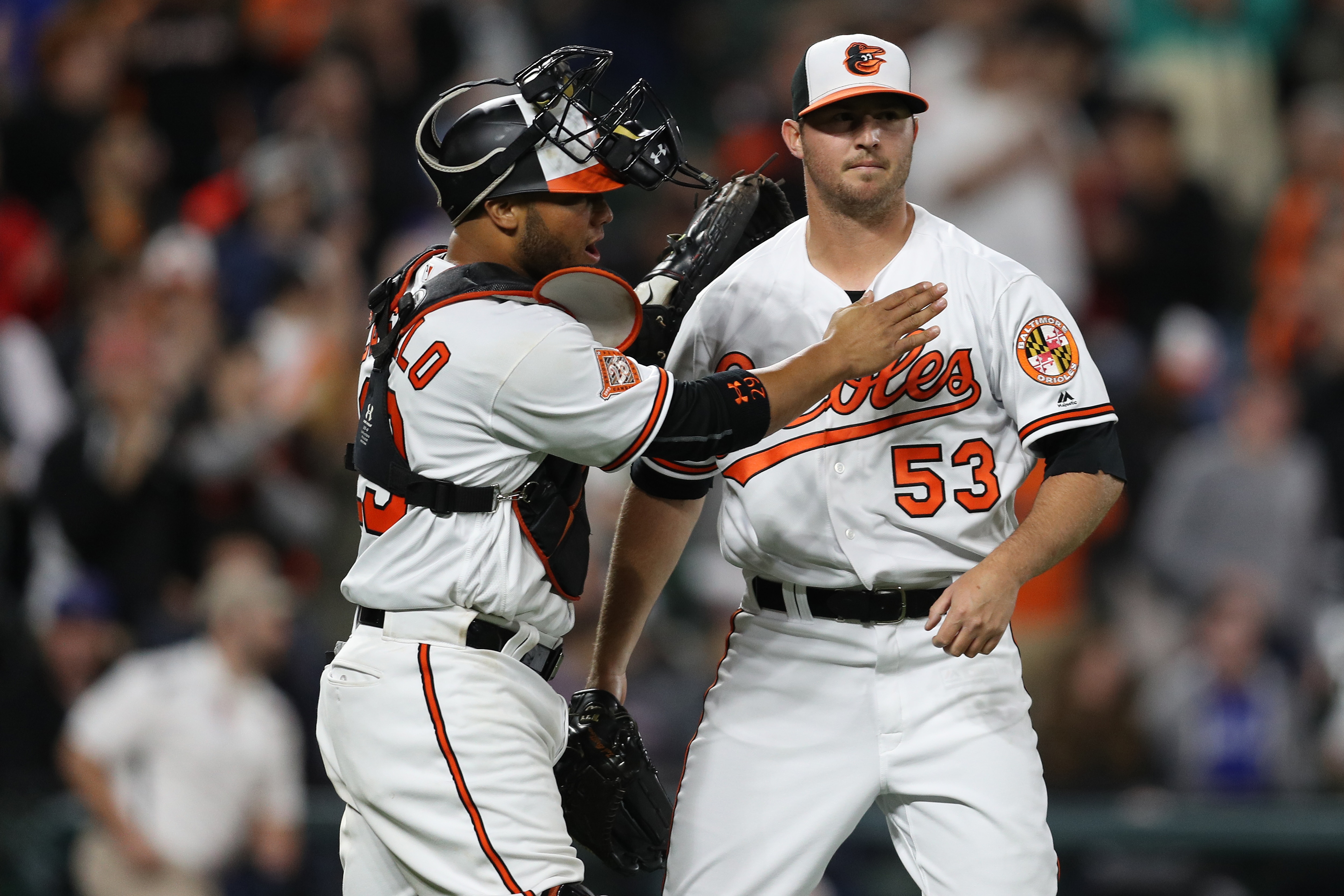 Catcher Welington Castillo congratulates Orioles closer Zack Britton after a game in 2017.