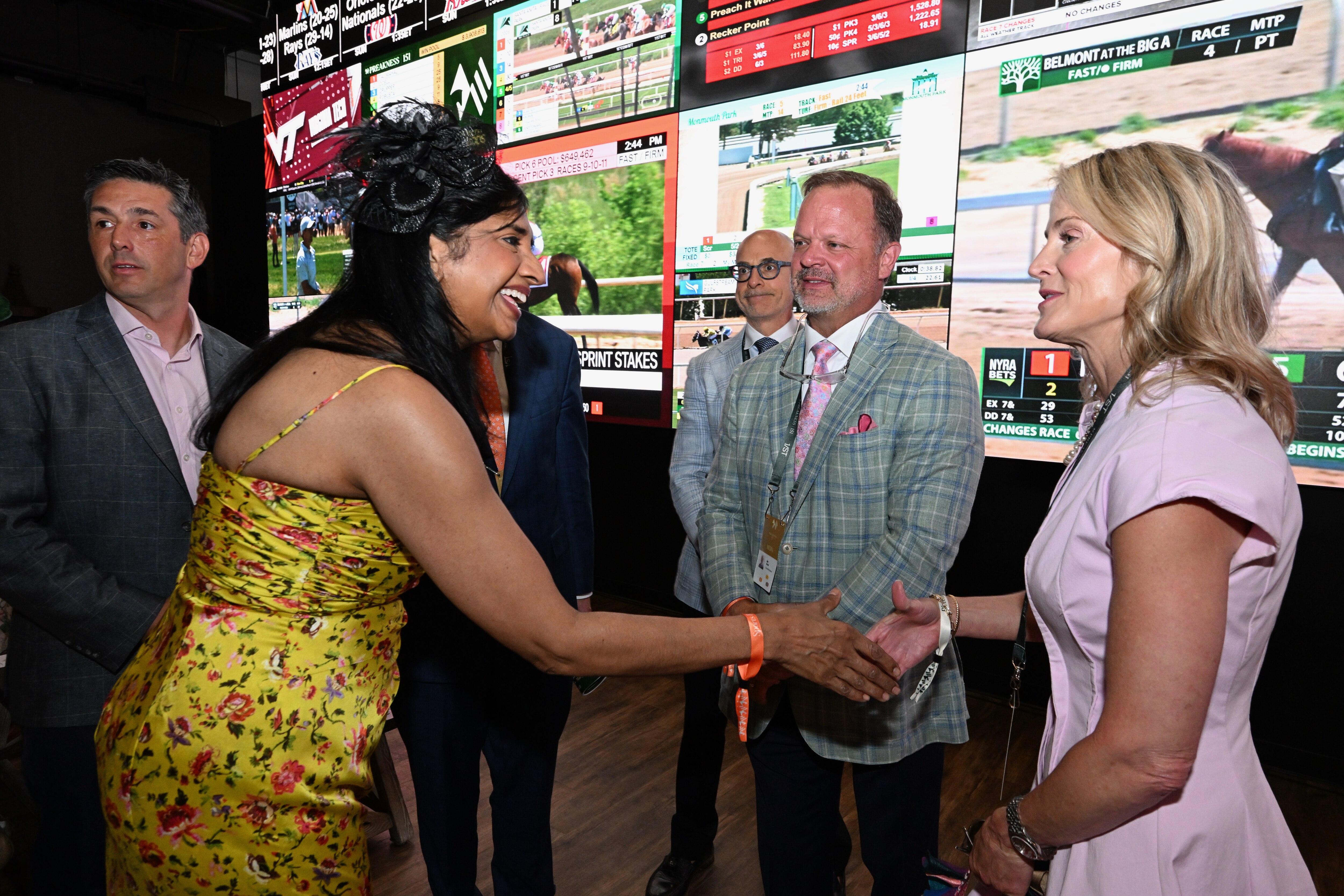 Lt. Gov. Aruna Miller greets Bill Mudd, president and chief operating officer of Churchill Downs, and his spouse, Michelle Mudd, during the 151st Preakness at Laurel Park racetrack on Saturday.