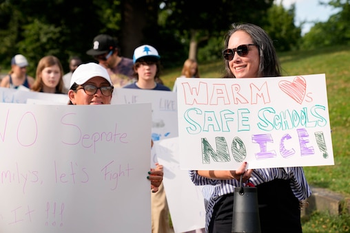 Heather Nolan, right, marches with other protesters during a rally at Patterson Park in Baltimore, Md. on Friday, June 12, 2026. The group of community members and parents gathered a day after U.S. Immigration and Customs Enforcement arrested a student’s parents on Commodore John Rodgers Elementary/Middle School’s temporary campus in East Baltimore.