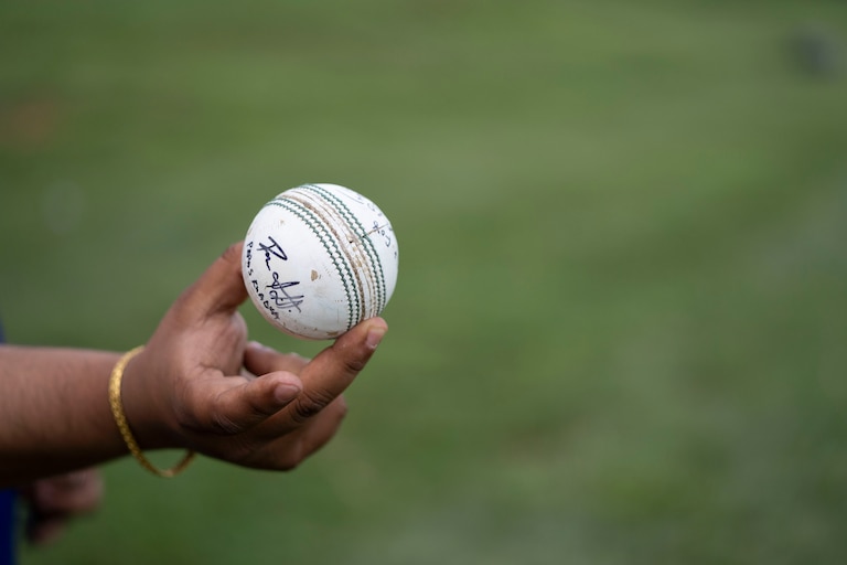 Utsav Sigdel, cricket director for Saathi Baltimore Cricket Club, shows off a signed ball. Sigdel got this ball at a professional match after it was hit out of bounds.