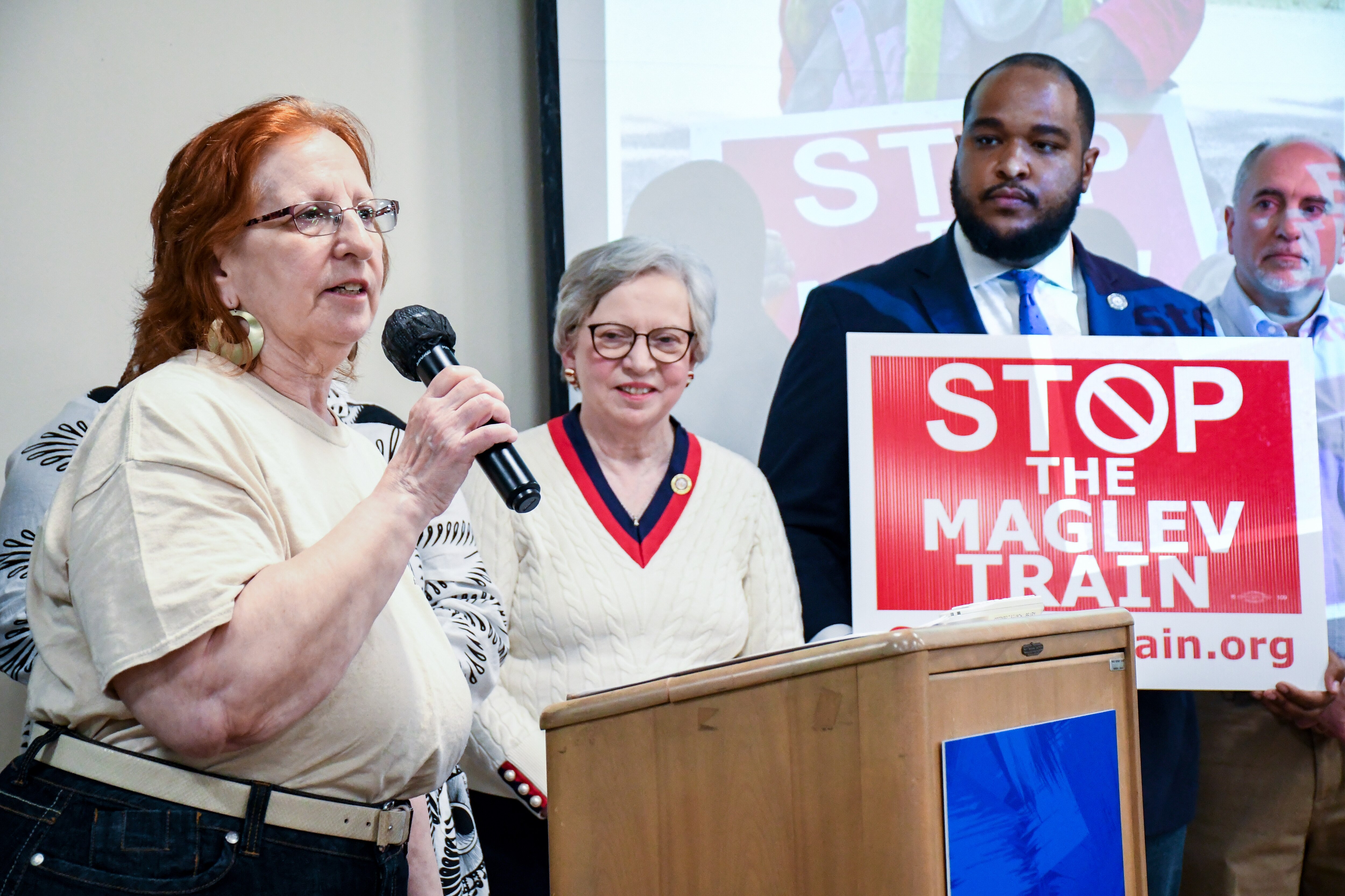 Susan McCutchen of Bladensburg, who has been fighting maglev for eight years, speaks at a community meeting at the Greenbelt library on Saturday, April 19, 2025. Next to her, from left, are Dels. Anne Healey and Ashanti Martinez and Prince George's County Councilman Eric Olson.
