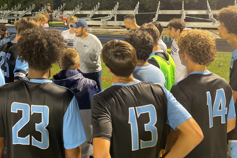 South River boys soccer coach Marlyn Argueta (center with hat) talks to his team during Monday evening's non-league contest with Bel Air. After 100 minutes of play, the Seahawks finished in a scoreless tie with the Bobcats in Anne Arundel County.