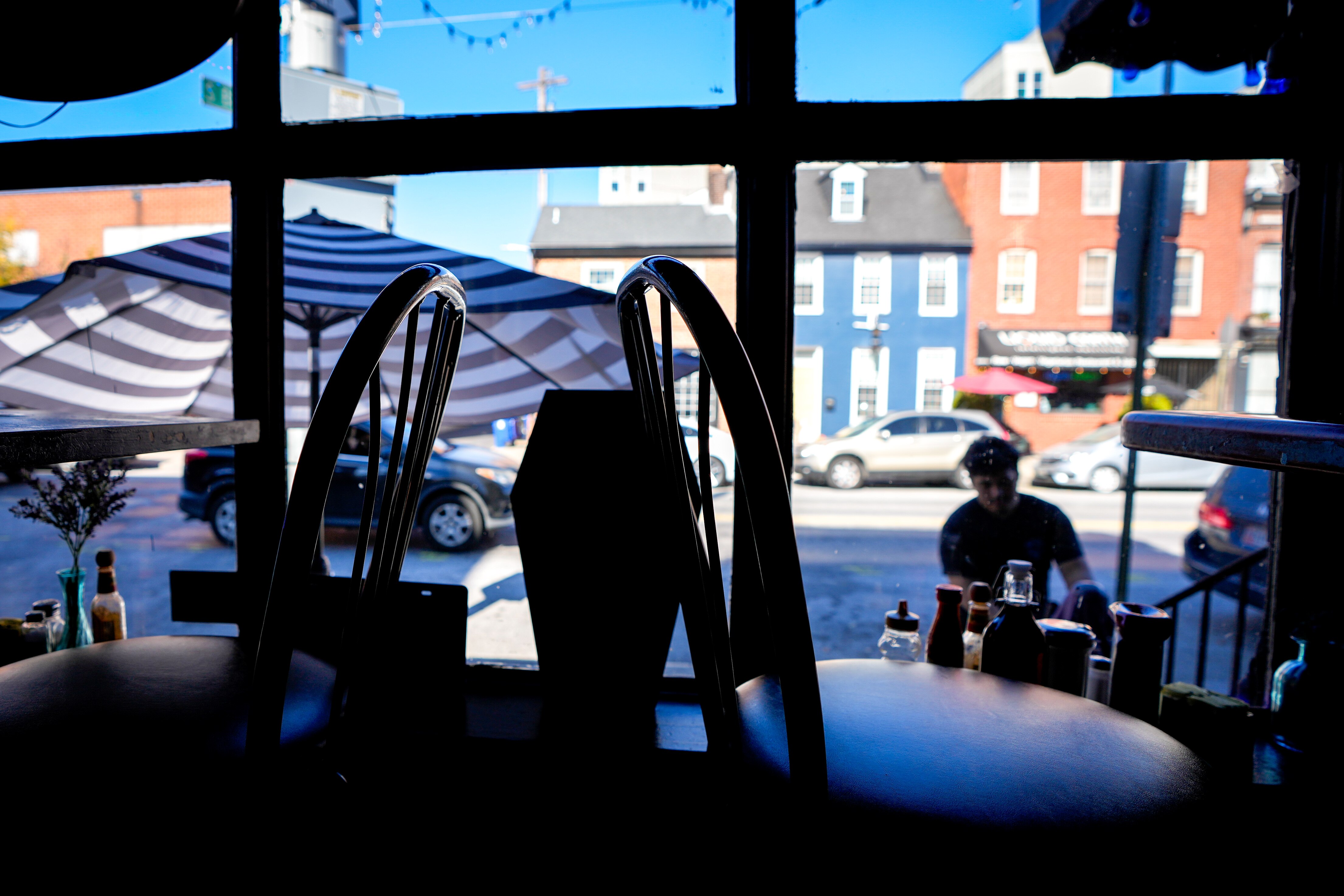Employee Julio Torres packs up outside seating at Blue Moon, a Fells Point restaurant with reported brushes with the supernatural.