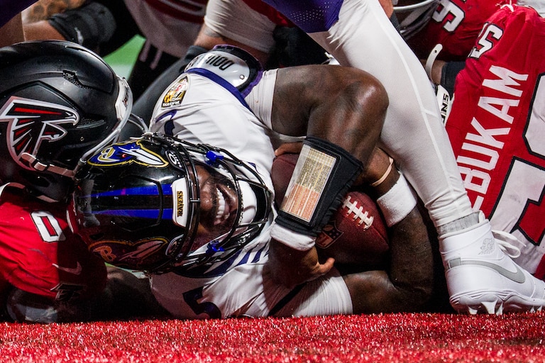 Baltimore Ravens quarterback Tyler Huntley (5) scores a touchdown