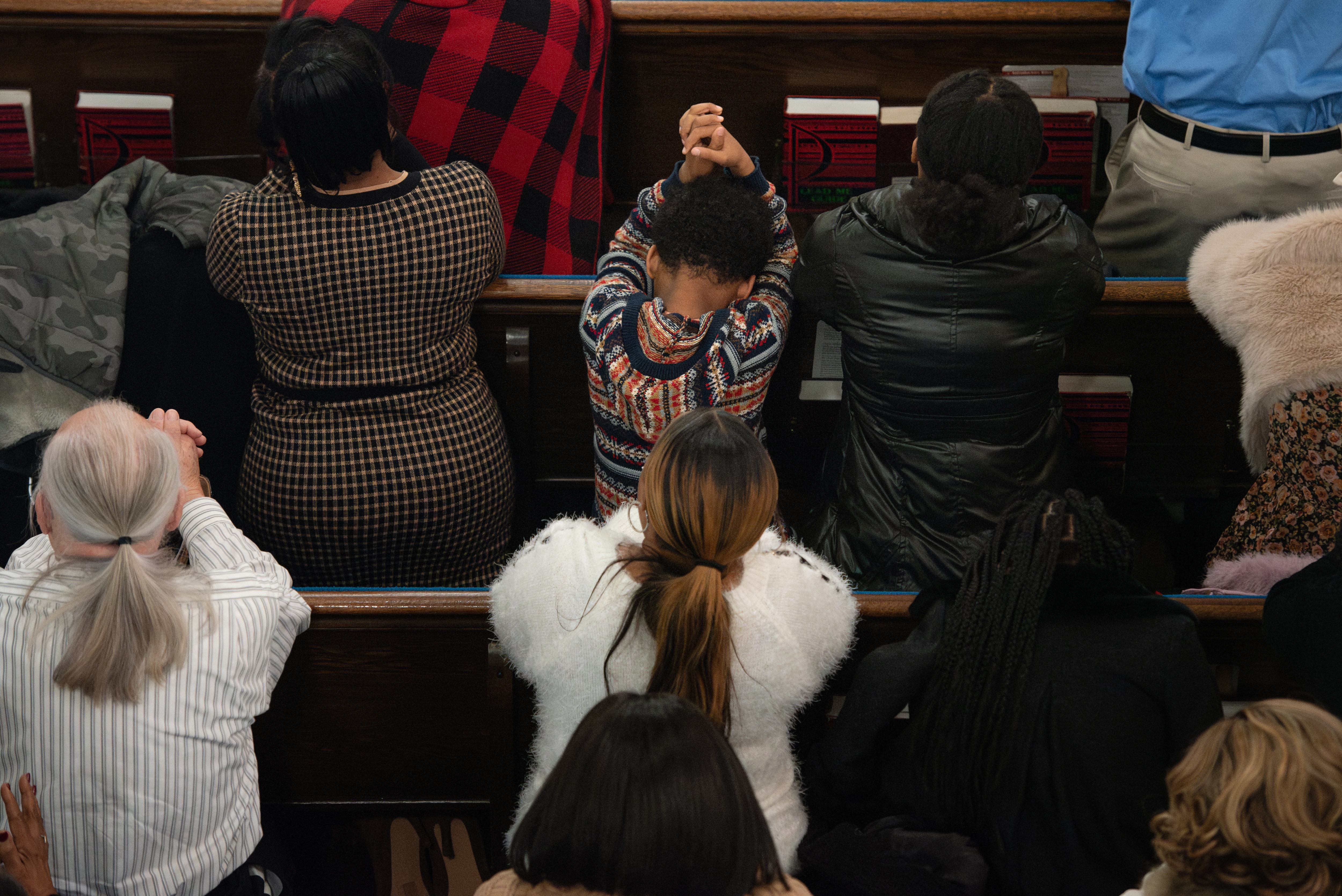 Parishioners of St. Bernardine Roman Catholic Church pray during mass on December 1, 2024 in Baltimore, Md.