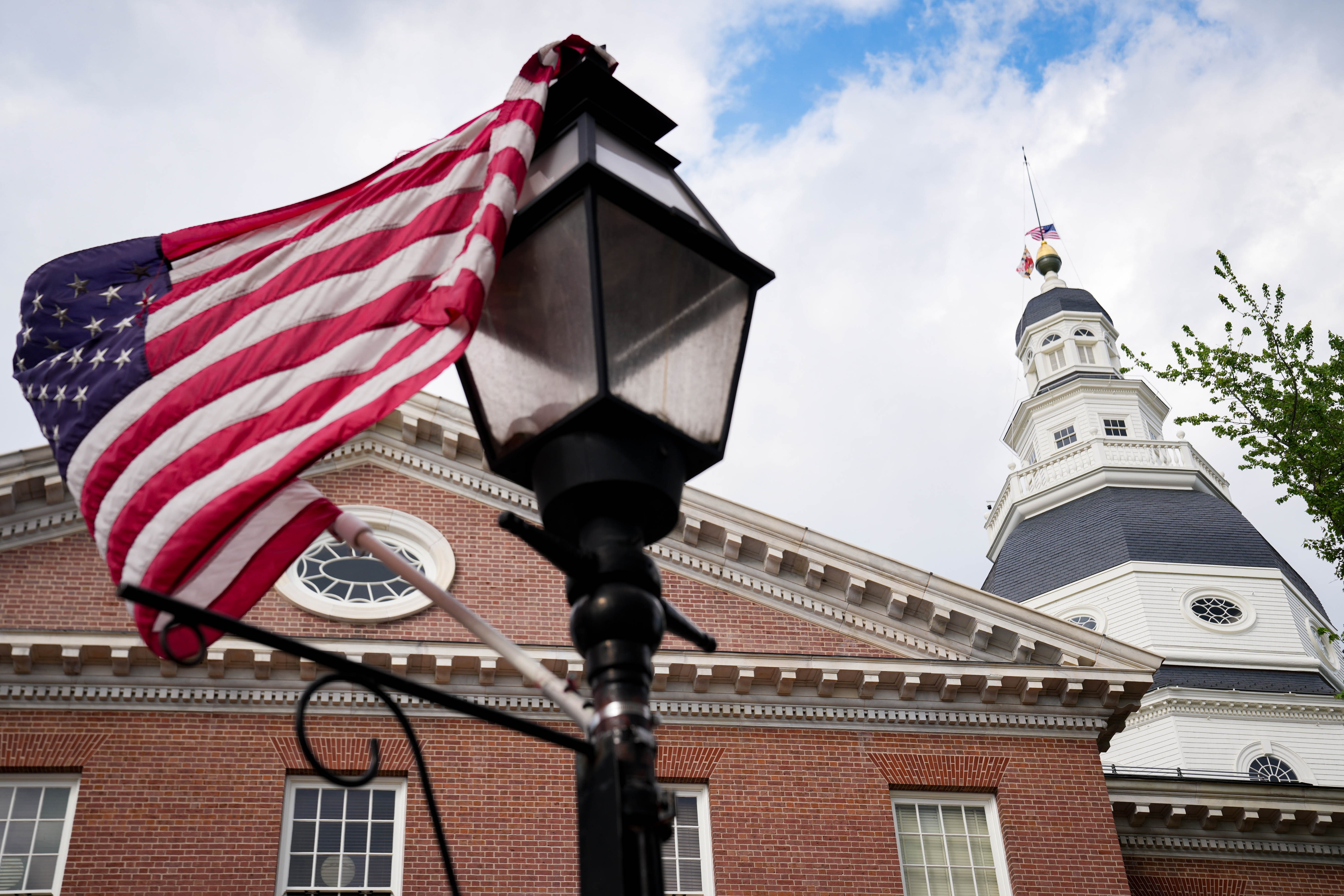 An American flag is caught on top of a lamppost in front of the Maryland State House dome in Annapolis, Md. on Thursday, May 15, 2025.