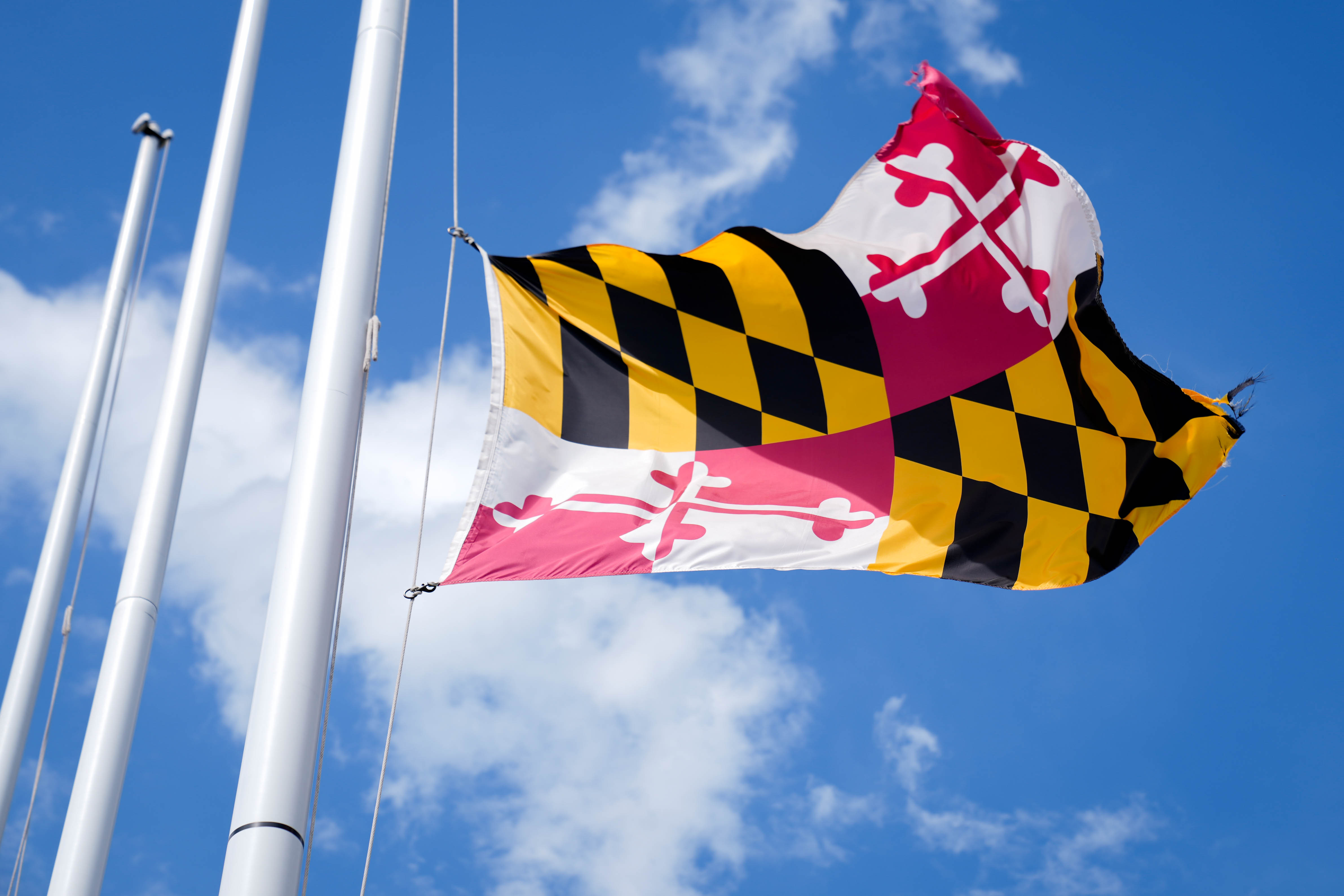 The Maryland State flag waves in the wind at the Mall in Columbia, Md. on Friday, May 2, 2025.