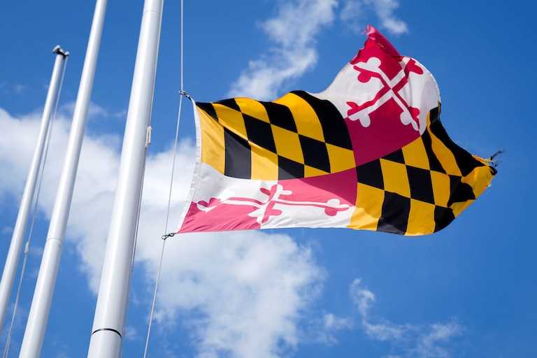 The Maryland State flag waves in the wind at the Mall in Columbia, Md. on Friday, May 2, 2025.