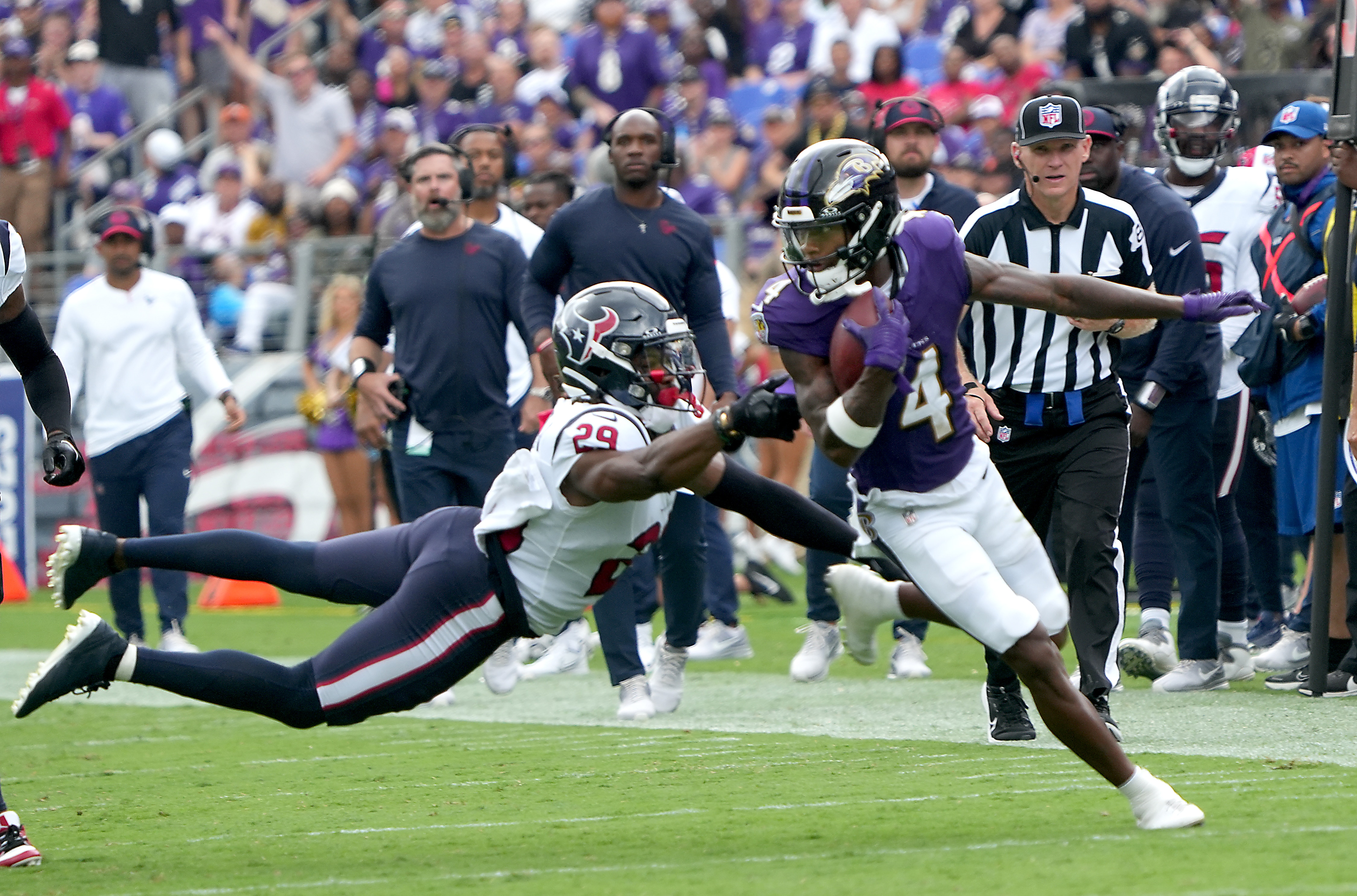 Baltimore Ravens wide receiver Zay Flowers (4) overts a diving tackle attempt by Texans safety #29 M.J. Stewart in the Ravens 25-9 victory over the Houston Texans at M&T Stadium Sept. 10, 2023