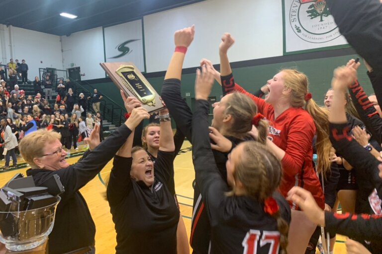Maryvale Prep coach Missy Little holds up the IAAM A Conference volleyball championship plaque Sunday evening. The No. 7 Lions won their second straight crown with a four-set victory over sixth-ranked Archbishop Spalding at Stevenson University.