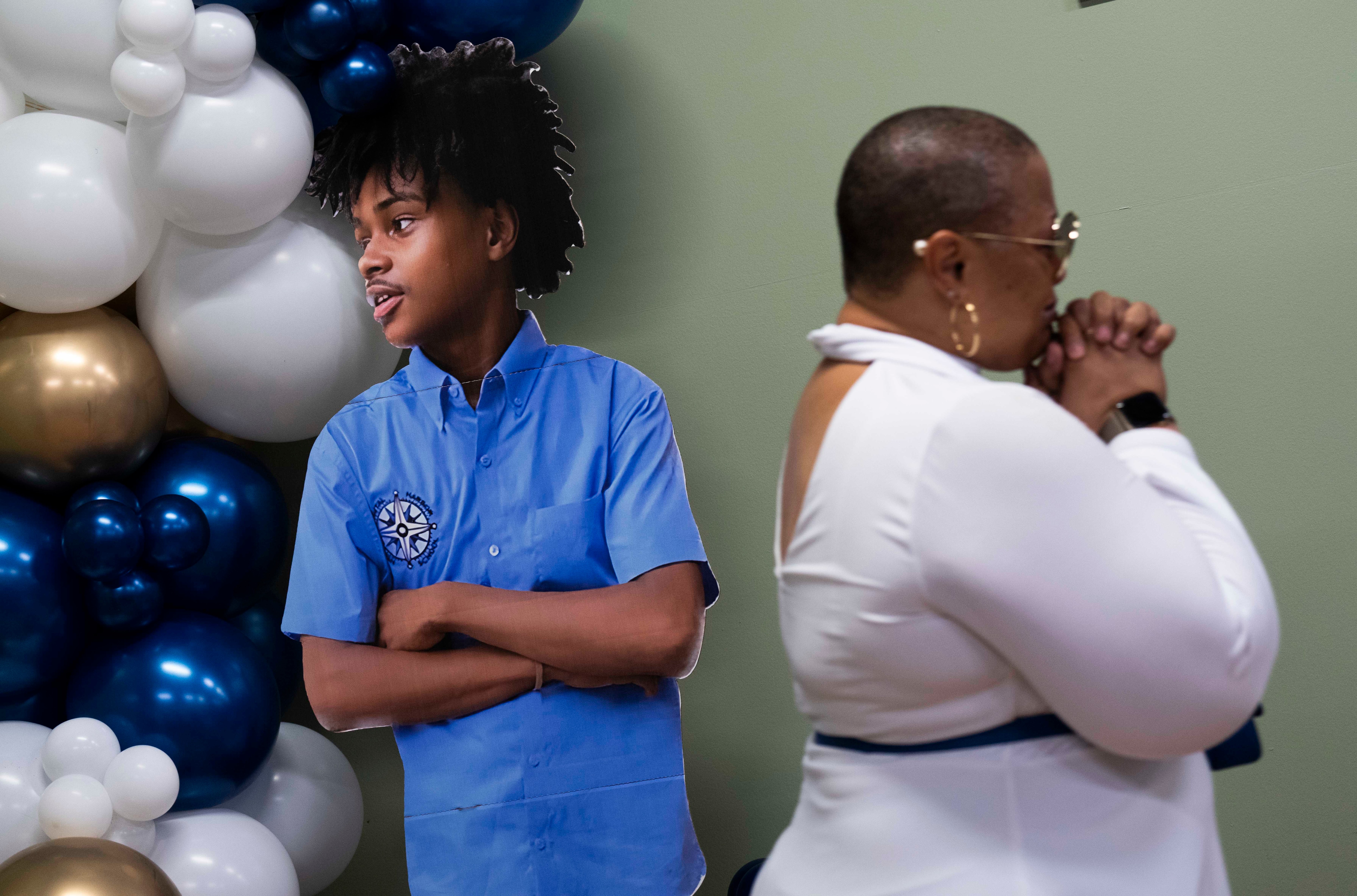 Bryson Hudson’s grandmother, Erica Colbert, who goes by “YaYa,” poses with a cardboard cutout of Hudson, 16, who was shot and killed this past August.