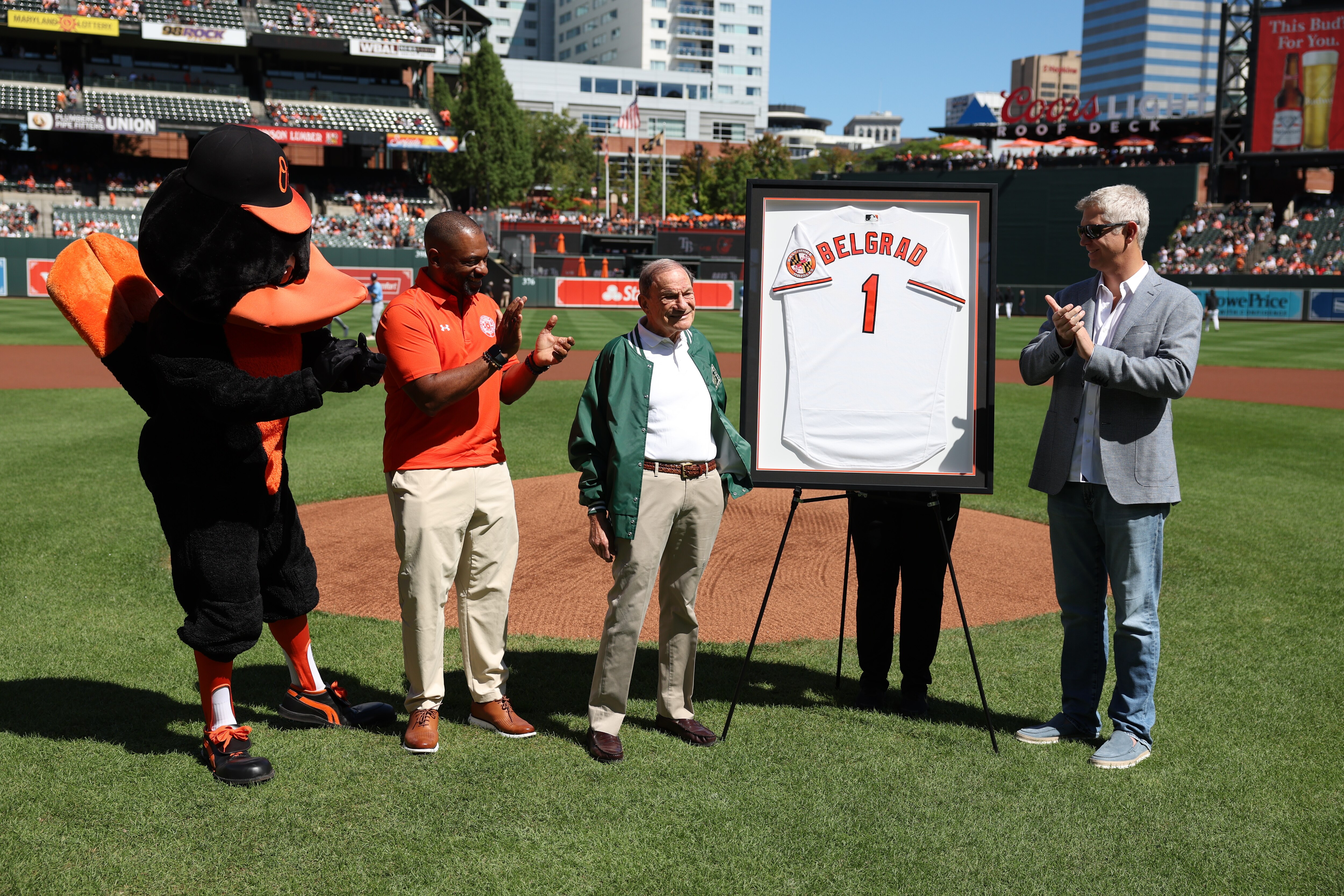 BALTIMORE, MARYLAND - September 08: Herbert “Herb” Belgrad, center, is presented with an honorary jersey before a game between the Tampa Bay Rays and Baltimore Orioles at Oriole Park at Camden Yards in Baltimore, Maryland on Sunday, September 8, 2024.