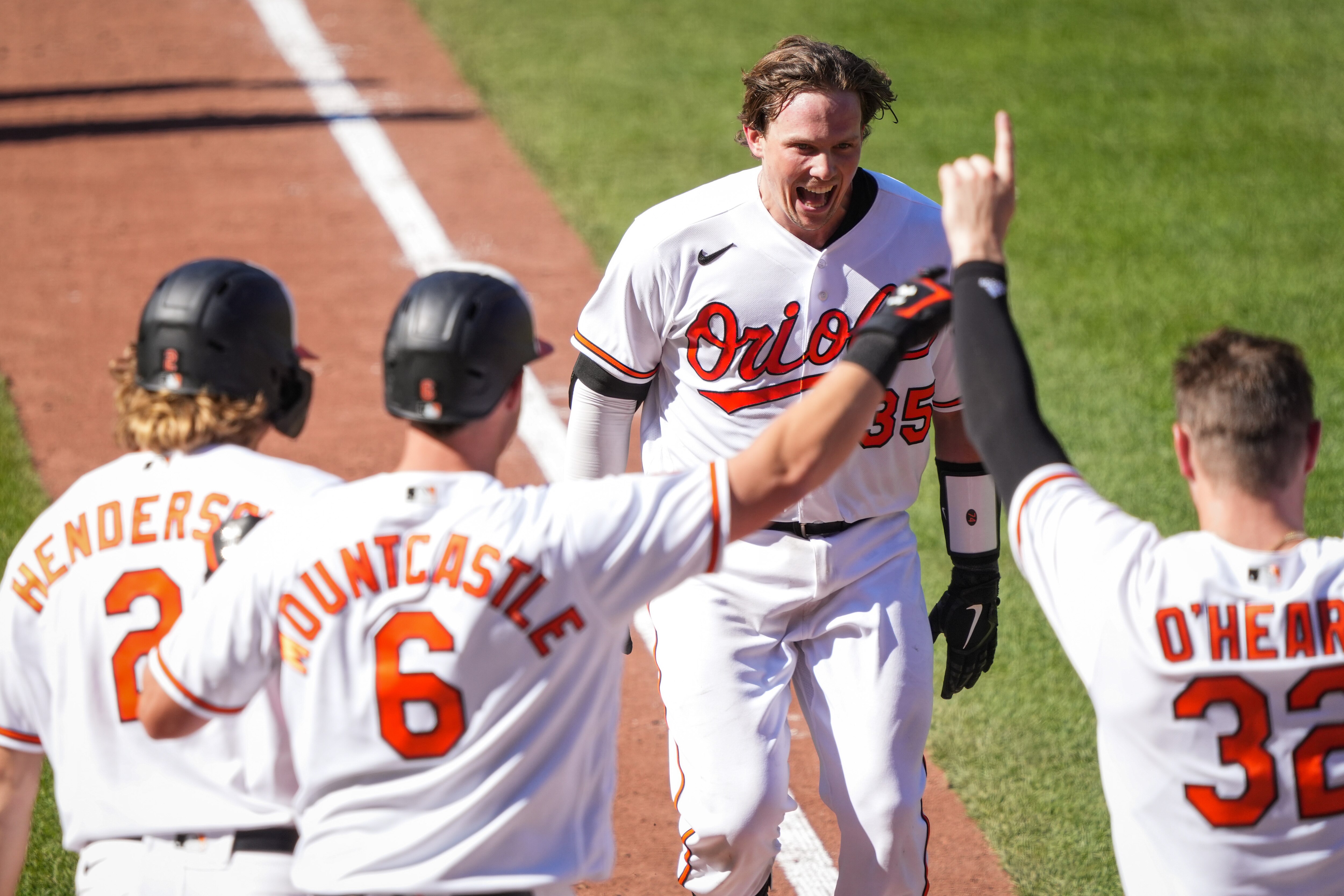 Baltimore Orioles catcher Adley Rutschman (35) celebrates with his team after hitting his first career walk-off homer to beat the Oakland Athletics, winning the 4-game series, at Camden Yards on Wednesday, April 12.