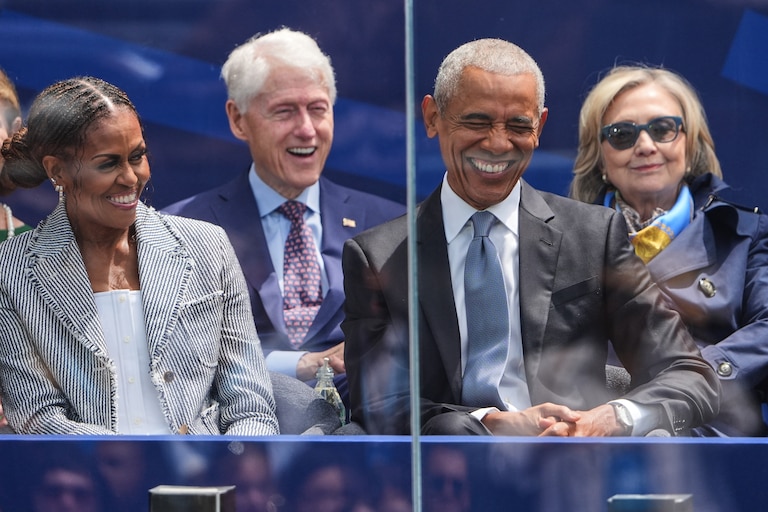 Former President Barack Obama, right, shares a laugh with former first lady Michelle Obama, left, on stage during the dedication ceremony for the Obama Presidential Center, Thursday, June 18, 2026, in Chicago.