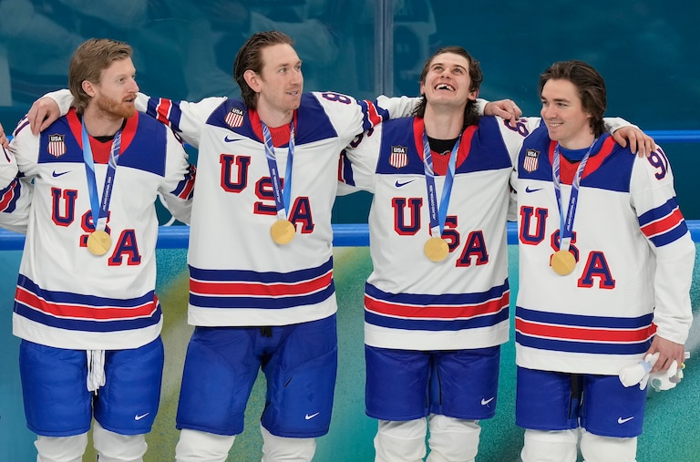 United States' Kyle Connor (81), Zach Werenski (8), Jack Hughes (86) and Clayton Keller (91) react after receiving their gold medals after the United States defeated Canada in the men's ice hockey gold medal game at the 2026 Winter Olympics, in Milan, Italy, Sunday, Feb. 22, 2026.