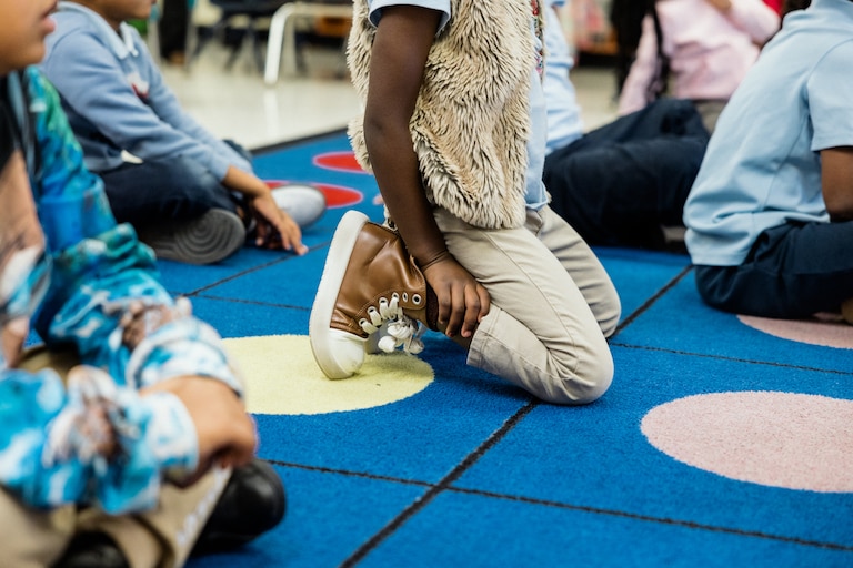 BALTIMORE, MD - DECEMBER 5, 2024: Kindergarten students pay attention to their teacher during an English Language Arts class in KIPP Harmony Academy on December 5, 2024.