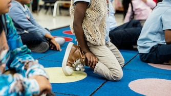BALTIMORE, MD - DECEMBER 5, 2024: Kindergarten students pay attention to their teacher during an English Language Arts class in KIPP Harmony Academy on December 5, 2024.