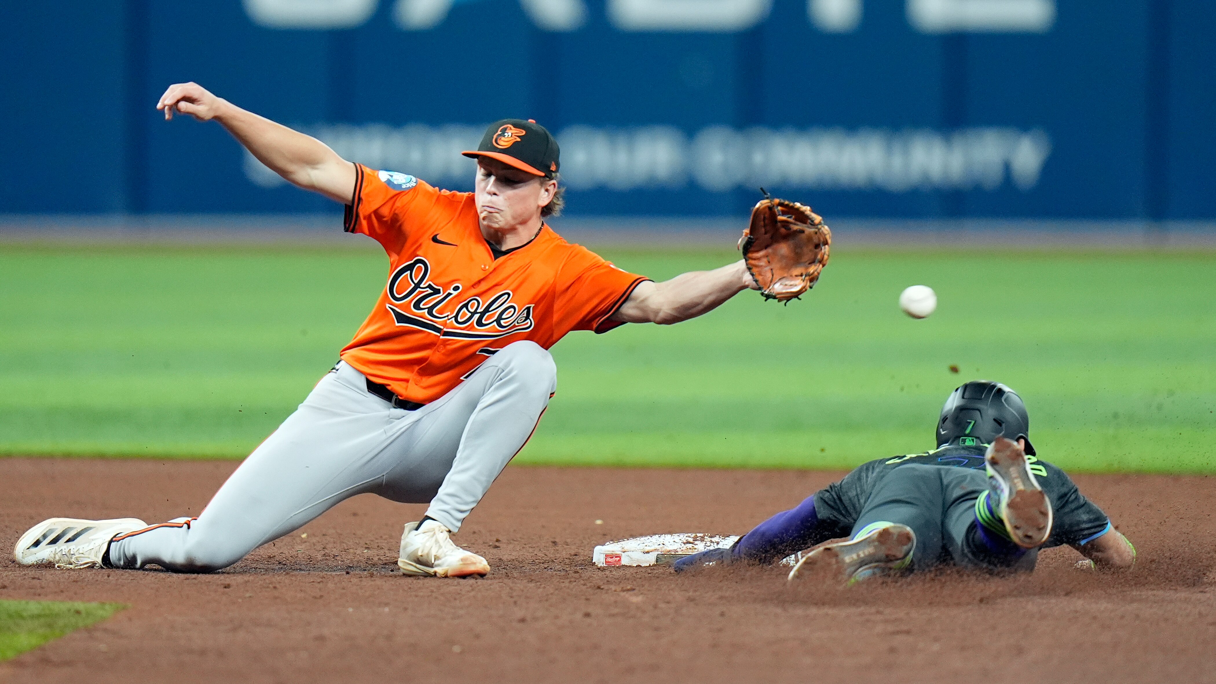 José Caballero (right) of the Rays steals second base as Jackson Holliday reaches for the throw.