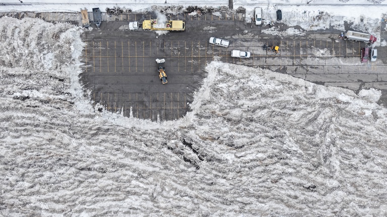 Front end loaders dump snow and ice into a snow melter at Lot O in Baltimore, Md., on Tuesday, February 3, 2026. Baltimore City has moved a large amount of snow and ice to Lot O as temperatures remain below freezing and crews work to keep streets clear.