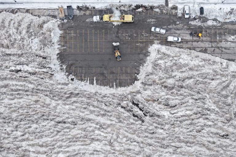 Front end loaders dump snow and ice into a snow melter at Lot O in Baltimore, Md., on Tuesday, February 3, 2026. Baltimore City has moved a large amount of snow and ice to Lot O as temperatures remain below freezing and crews work to keep streets clear.