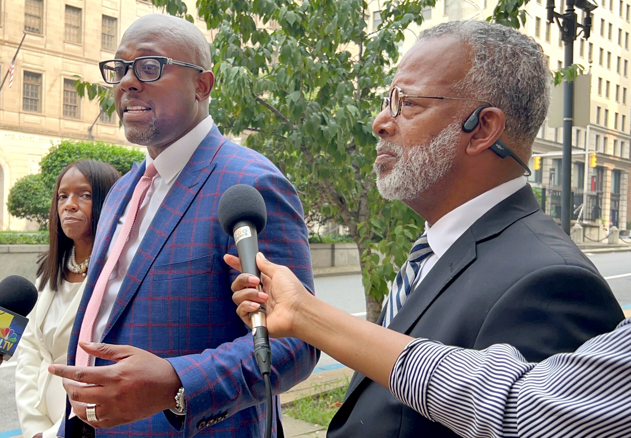 J. Wyndal Gordon, left, an attorney in Baltimore who represents a 16-year-old accused of shooting and killing a man who confronted a group of squeegee workers with a baseball bat in 2022, speaks to reporters on Monday after jury selection in the case in the Clarence M. Mitchell Jr. Courthouse. His co-counsel, Warren Brown, is seen on the right. 