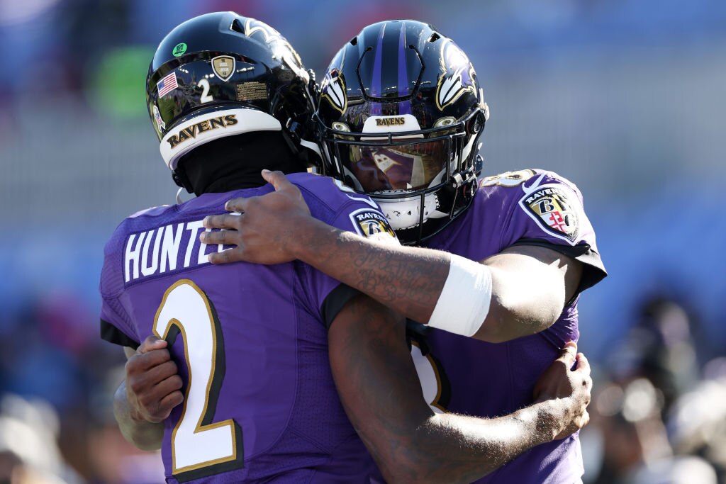 Lamar Jackson #8 and Tyler Huntley #2 of the Baltimore Ravens hug before a game against the Carolina Panthers at M&T Bank Stadium on Nov. 20, 2022 in Baltimore, Maryland. (Photo by Scott Taetsch/Getty Images)